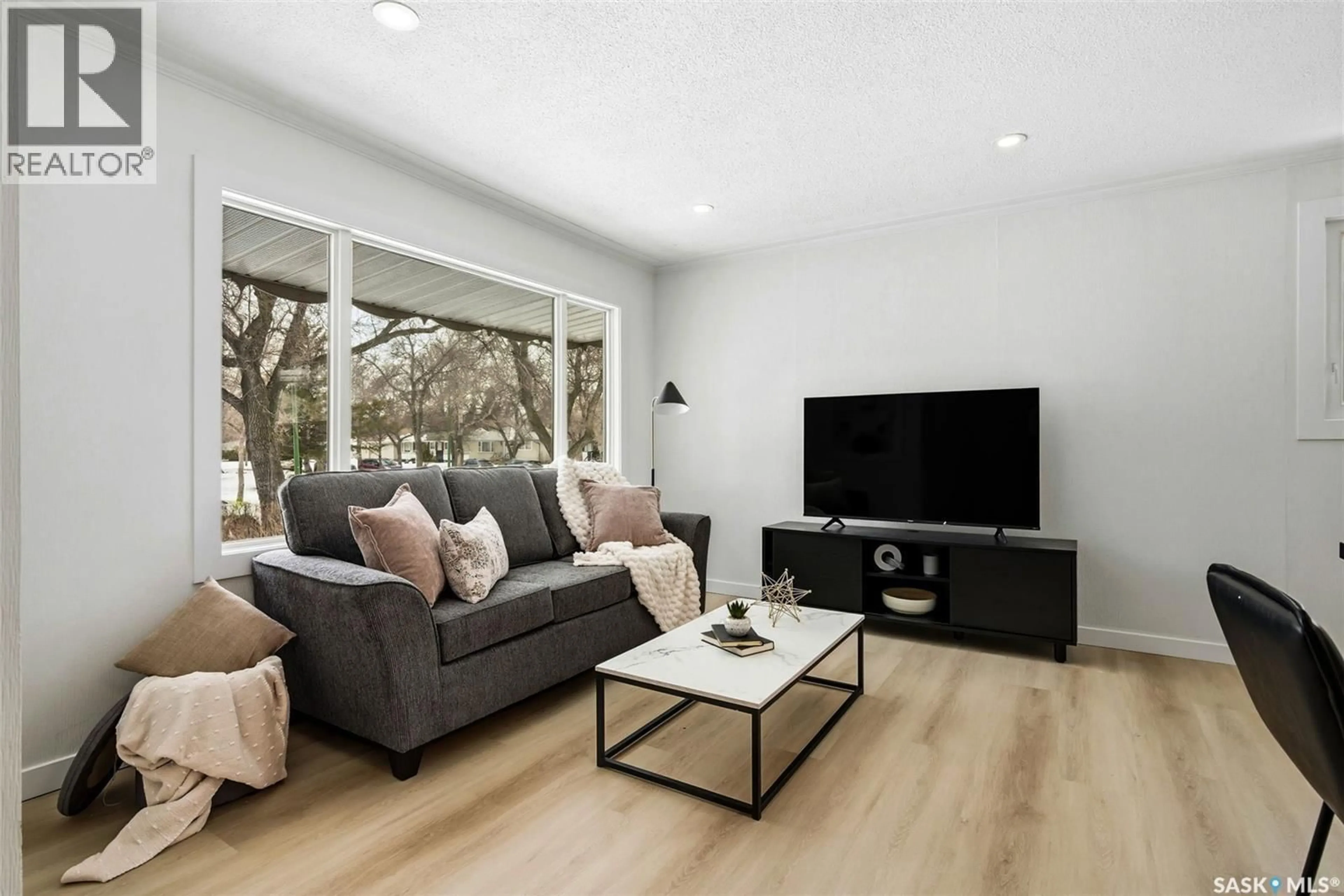 Living room with furniture, wood/laminate floor for 5012 1ST AVENUE, Regina Saskatchewan S4T0A5