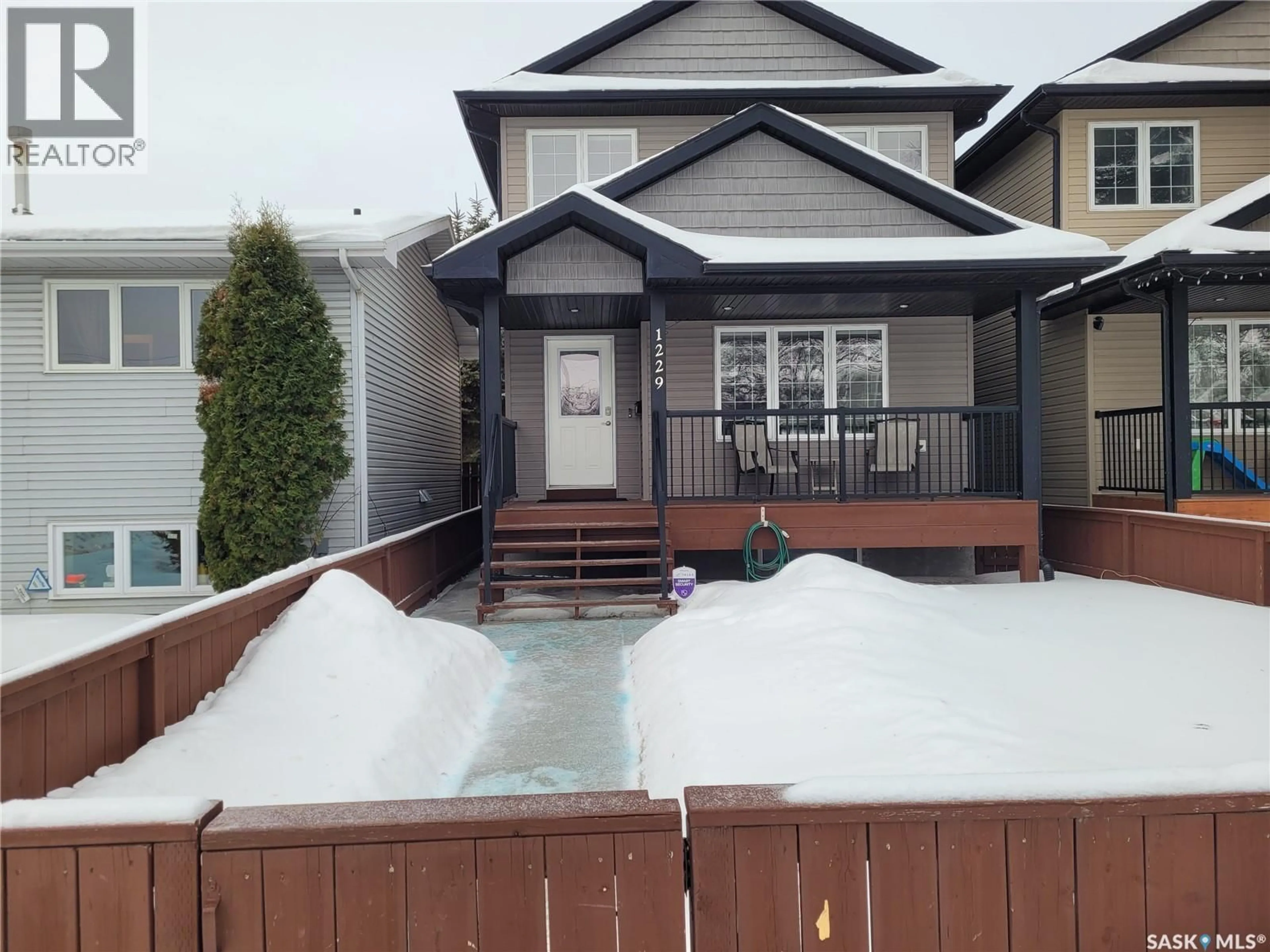 Home with vinyl exterior material, street for 1229 2ND AVENUE N, Saskatoon Saskatchewan S7K2E3