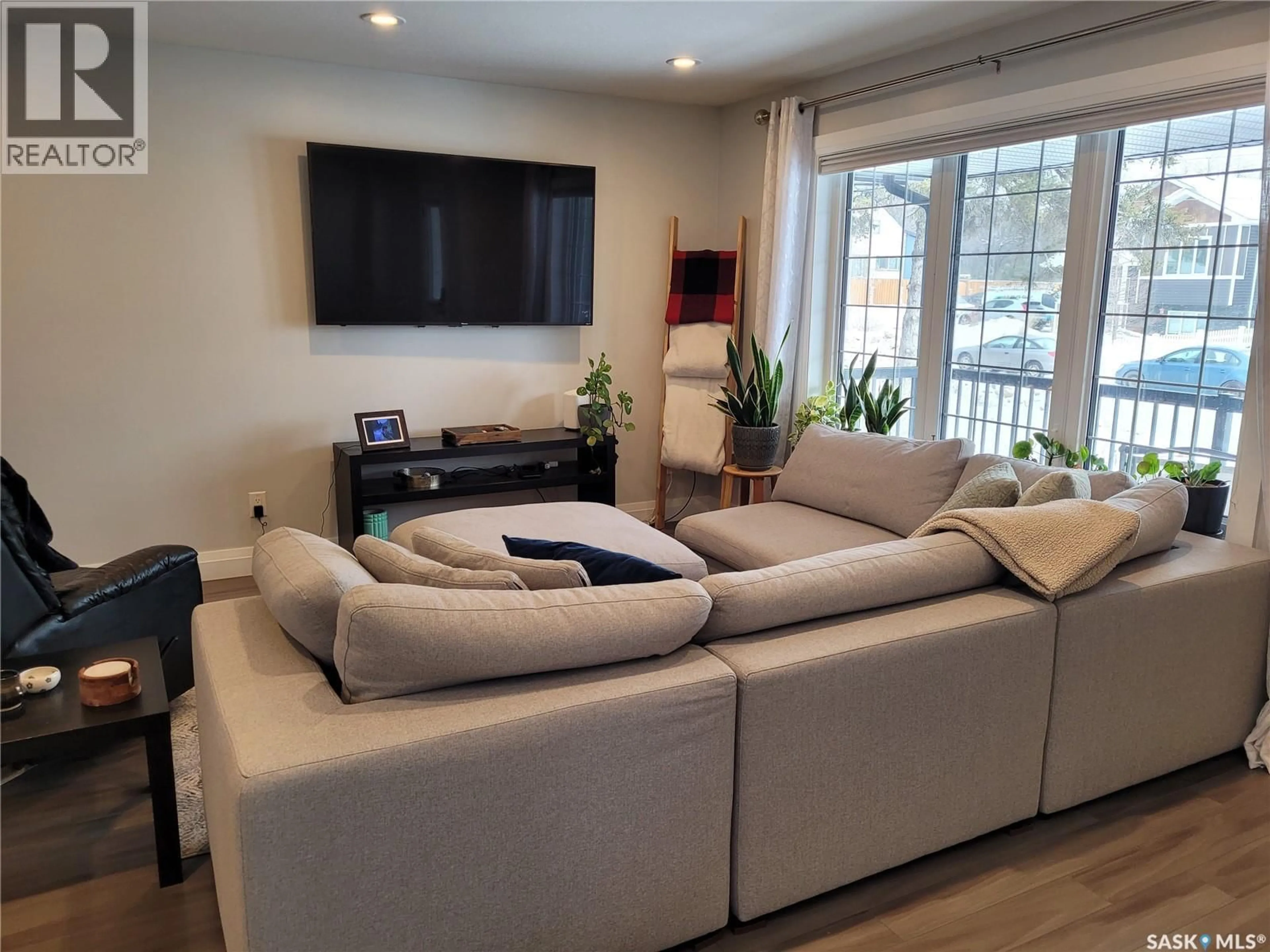 Living room with furniture, wood/laminate floor for 1229 2ND AVENUE N, Saskatoon Saskatchewan S7K2E3