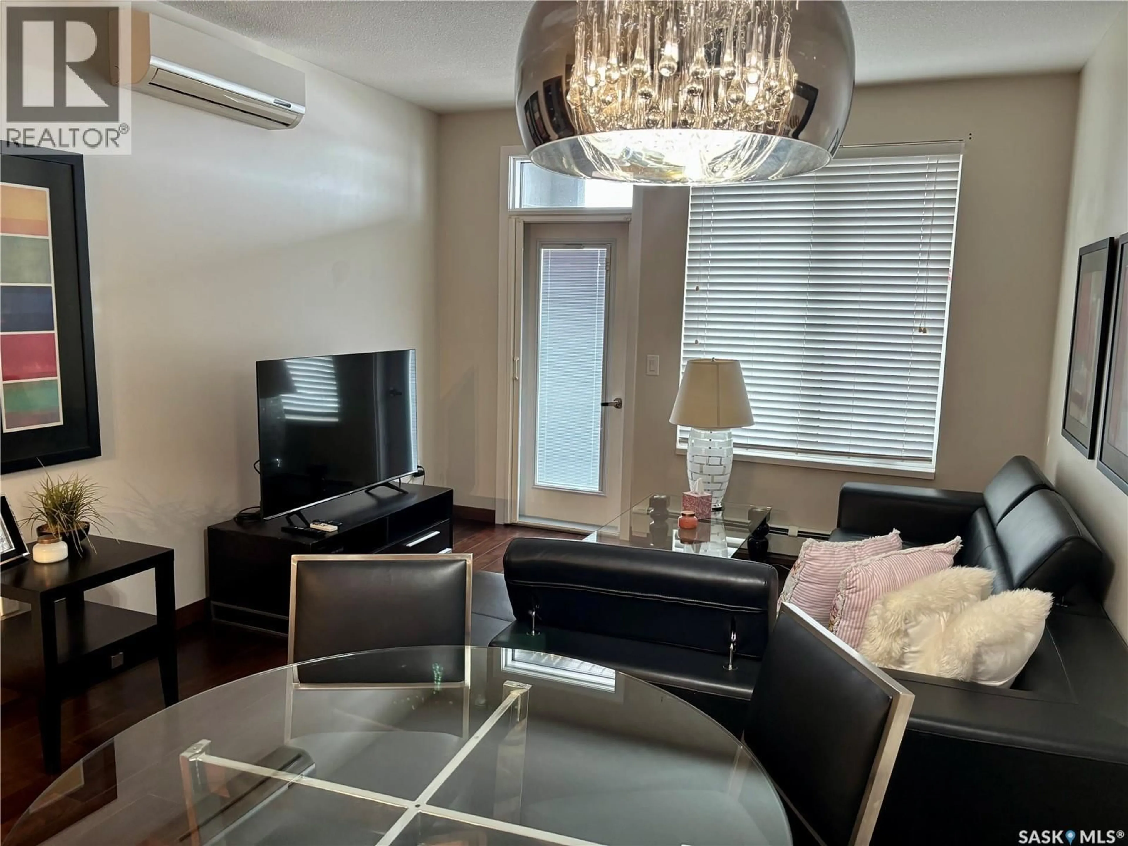 Living room with furniture, wood/laminate floor for 203 - 2101 HESELTINE ROAD, Regina Saskatchewan S4V3H1
