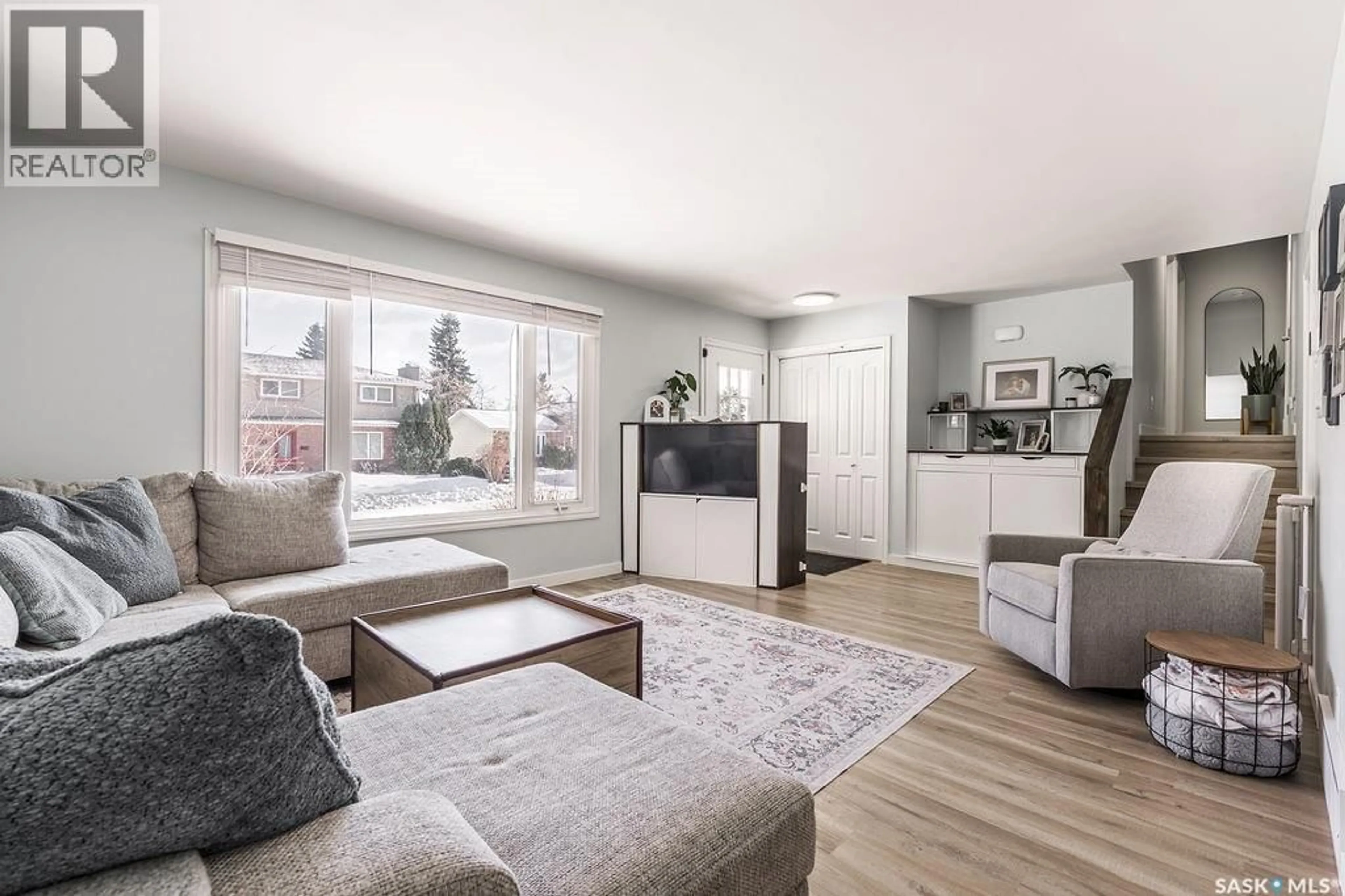 Living room with furniture, wood/laminate floor for 11 SCHWAGER CRESCENT, Saskatoon Saskatchewan S7H5C1