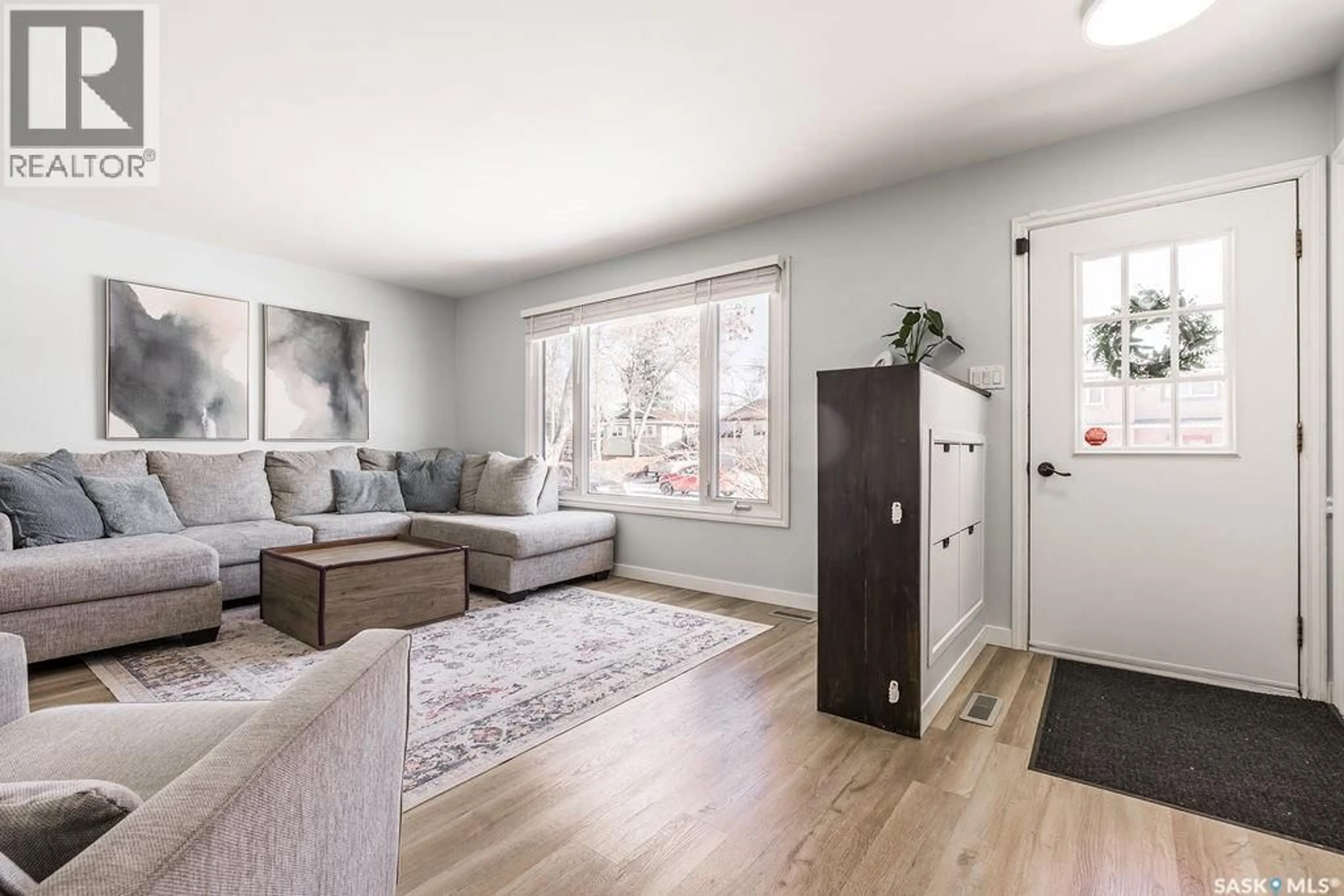 Living room with furniture, wood/laminate floor for 11 SCHWAGER CRESCENT, Saskatoon Saskatchewan S7H5C1