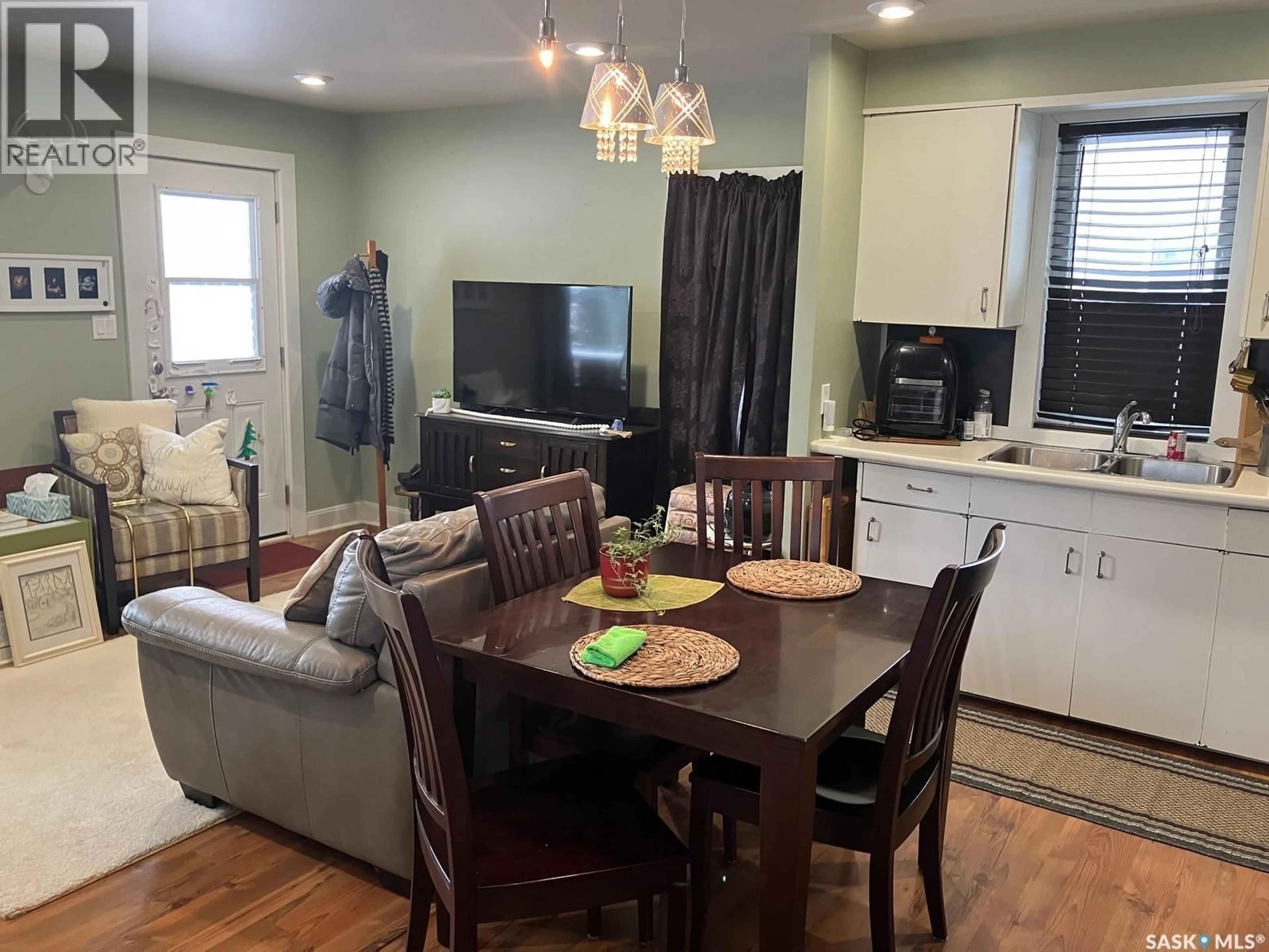 Living room with furniture, wood/laminate floor for 413 8TH AVENUE, Nipawin Saskatchewan S0E1E0