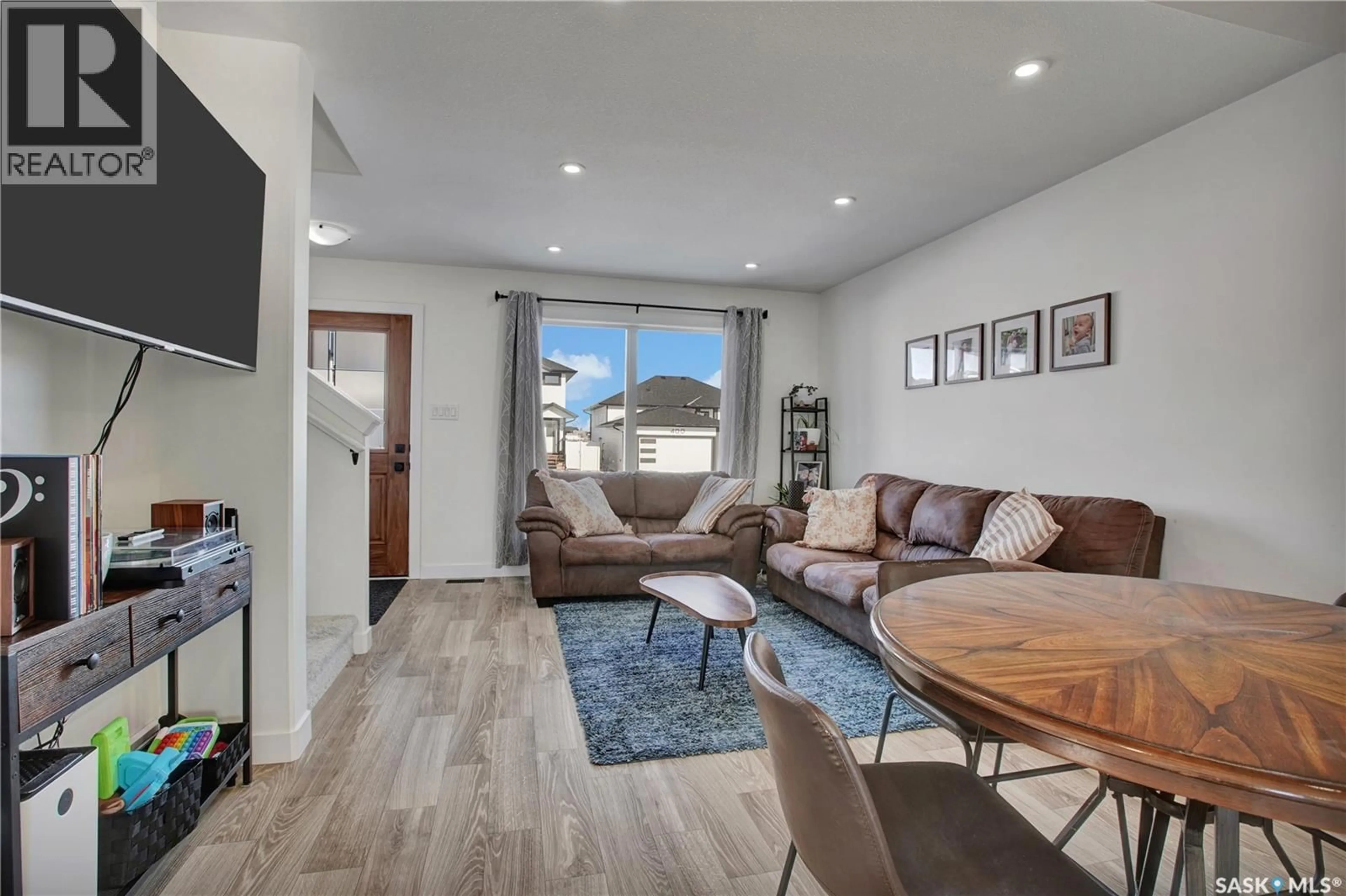 Living room with furniture, wood/laminate floor for 403 ELDORADO STREET, Warman Saskatchewan S0K4S3