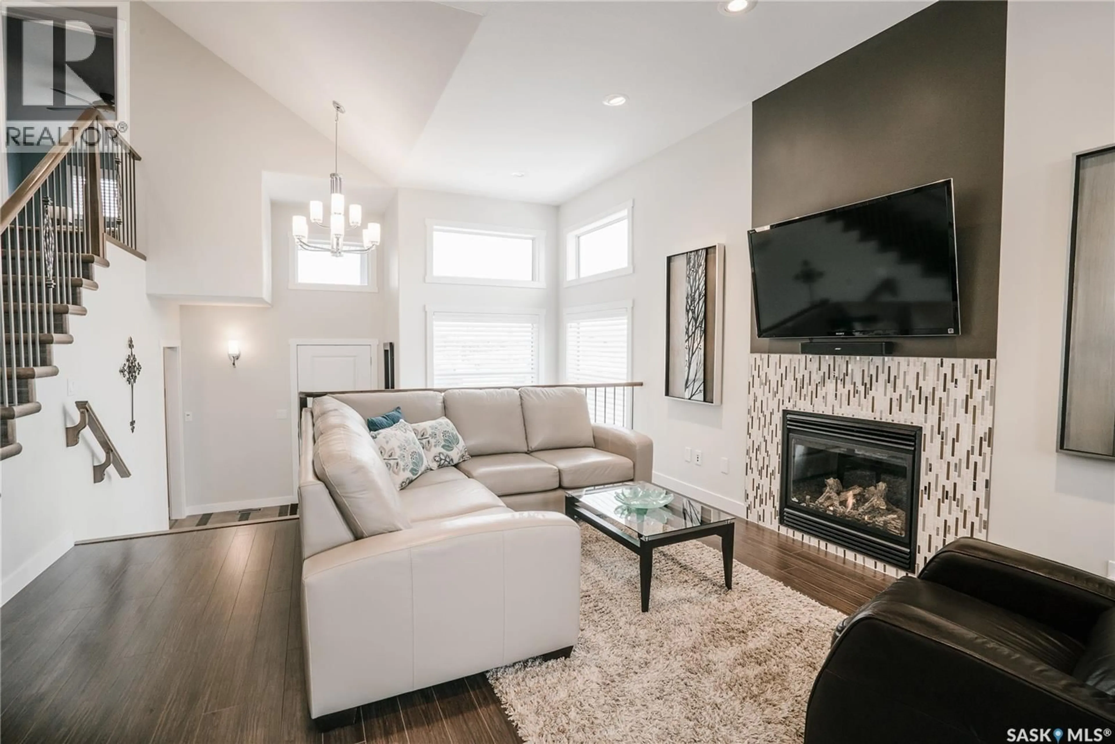 Living room with furniture, wood/laminate floor for 458 TEAL LANE, Saskatoon Saskatchewan S7T0R2