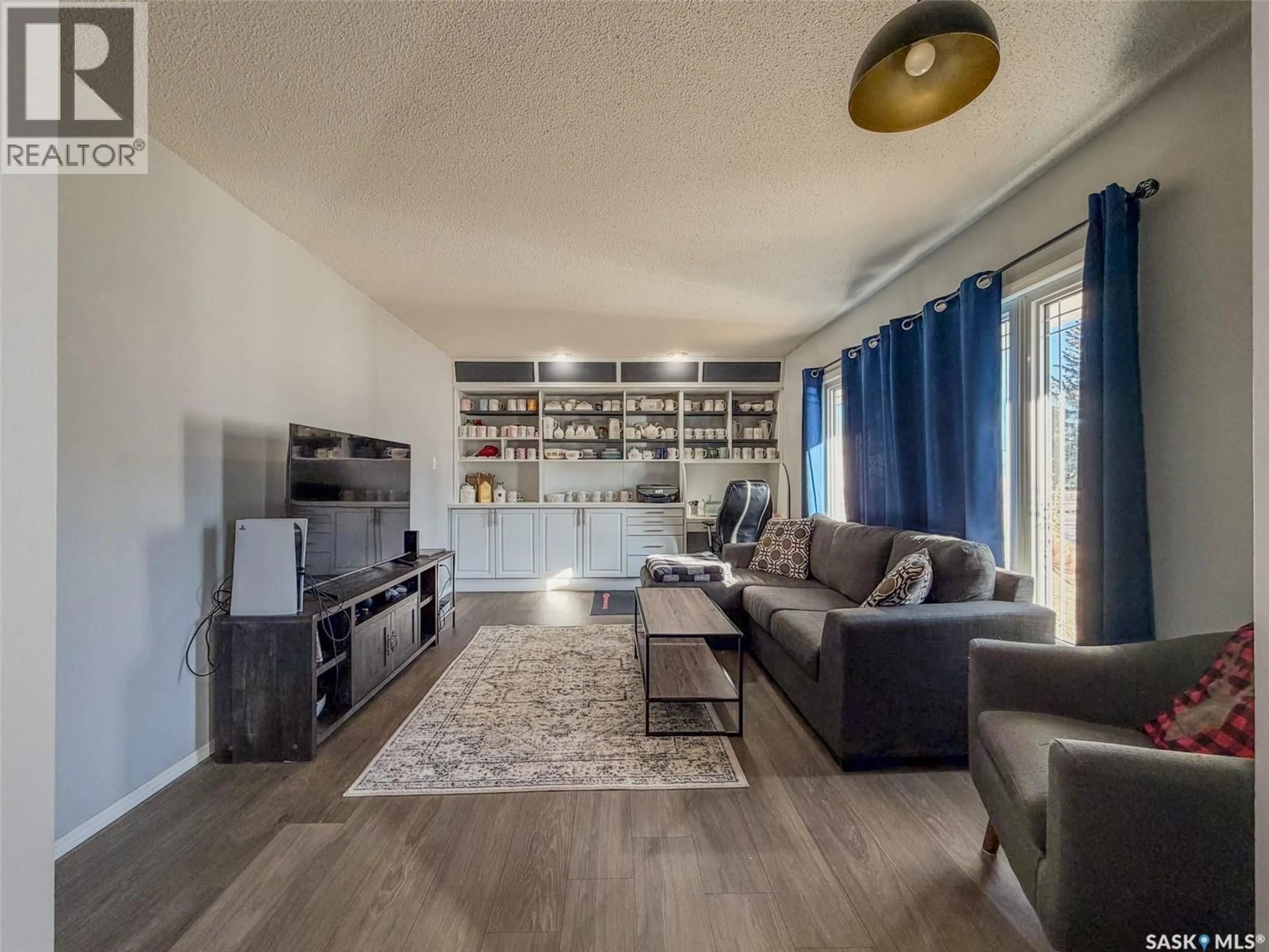 Living room with furniture, wood/laminate floor for E - 405 5TH STREET, Shaunavon Saskatchewan S0N2M0