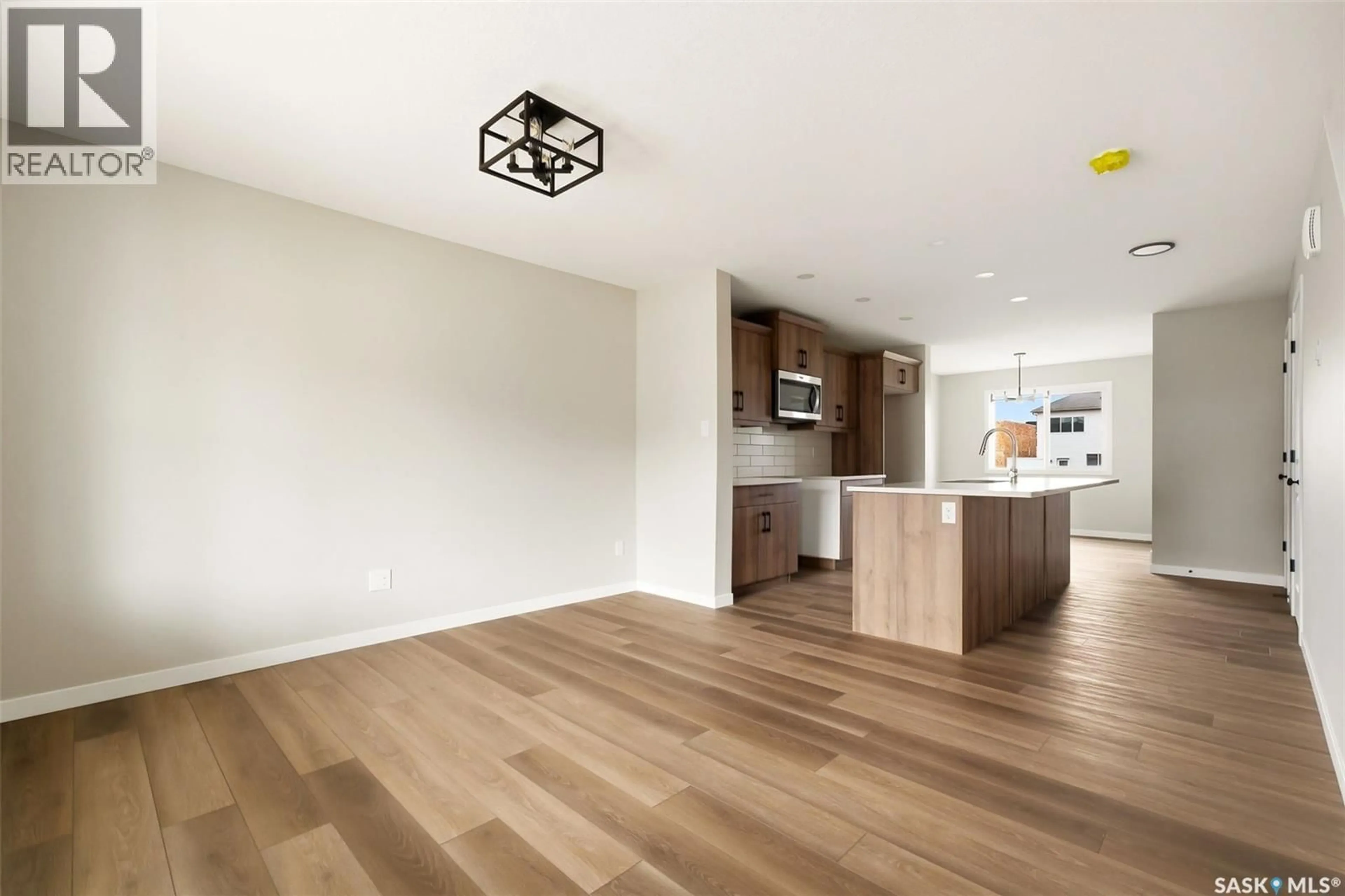 Open concept kitchen, wood/laminate floor for 3148 GREEN TURTLE ROAD, Regina Saskatchewan S4V4C5