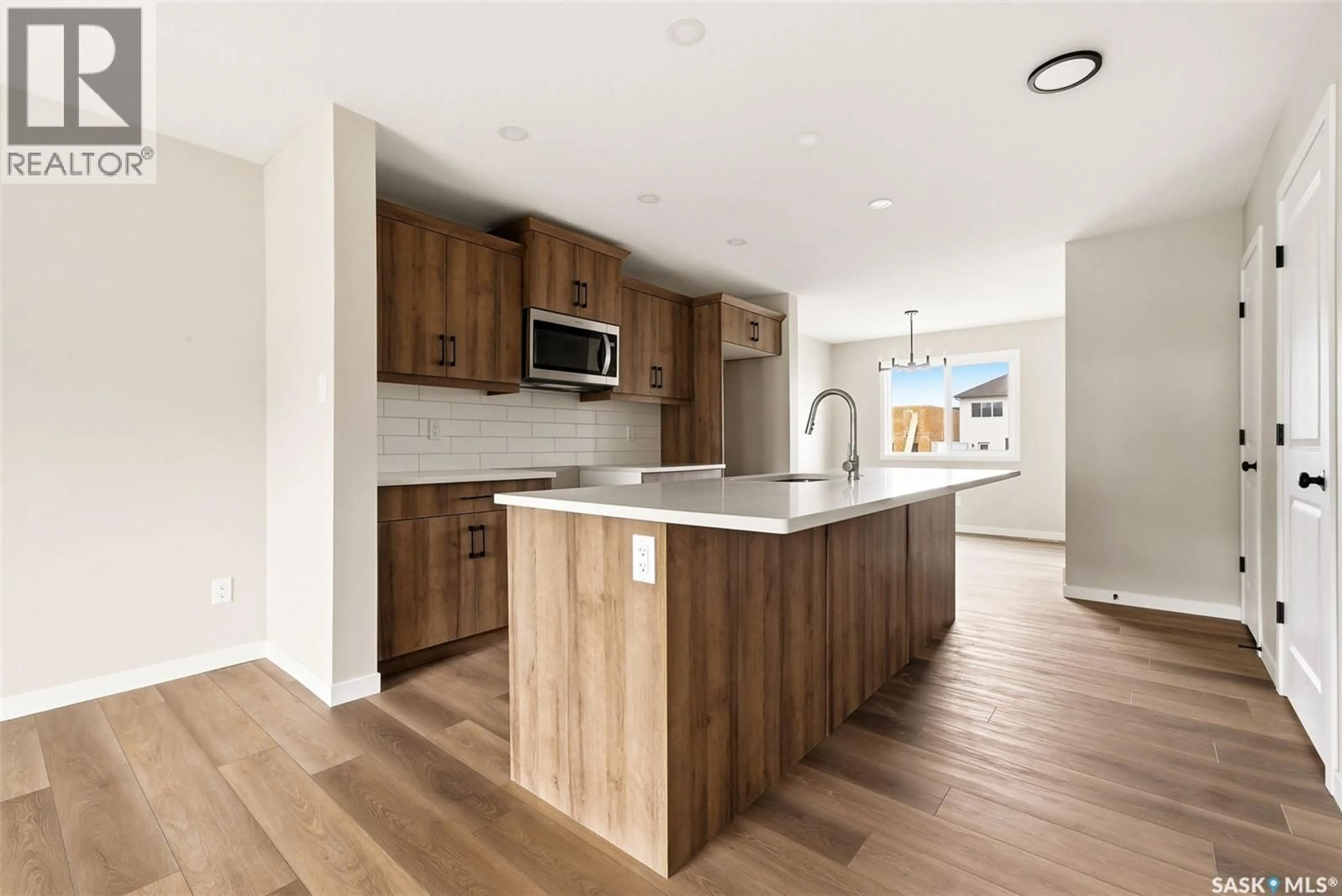 Open concept kitchen, wood/laminate floor for 3148 GREEN TURTLE ROAD, Regina Saskatchewan S4V4C5