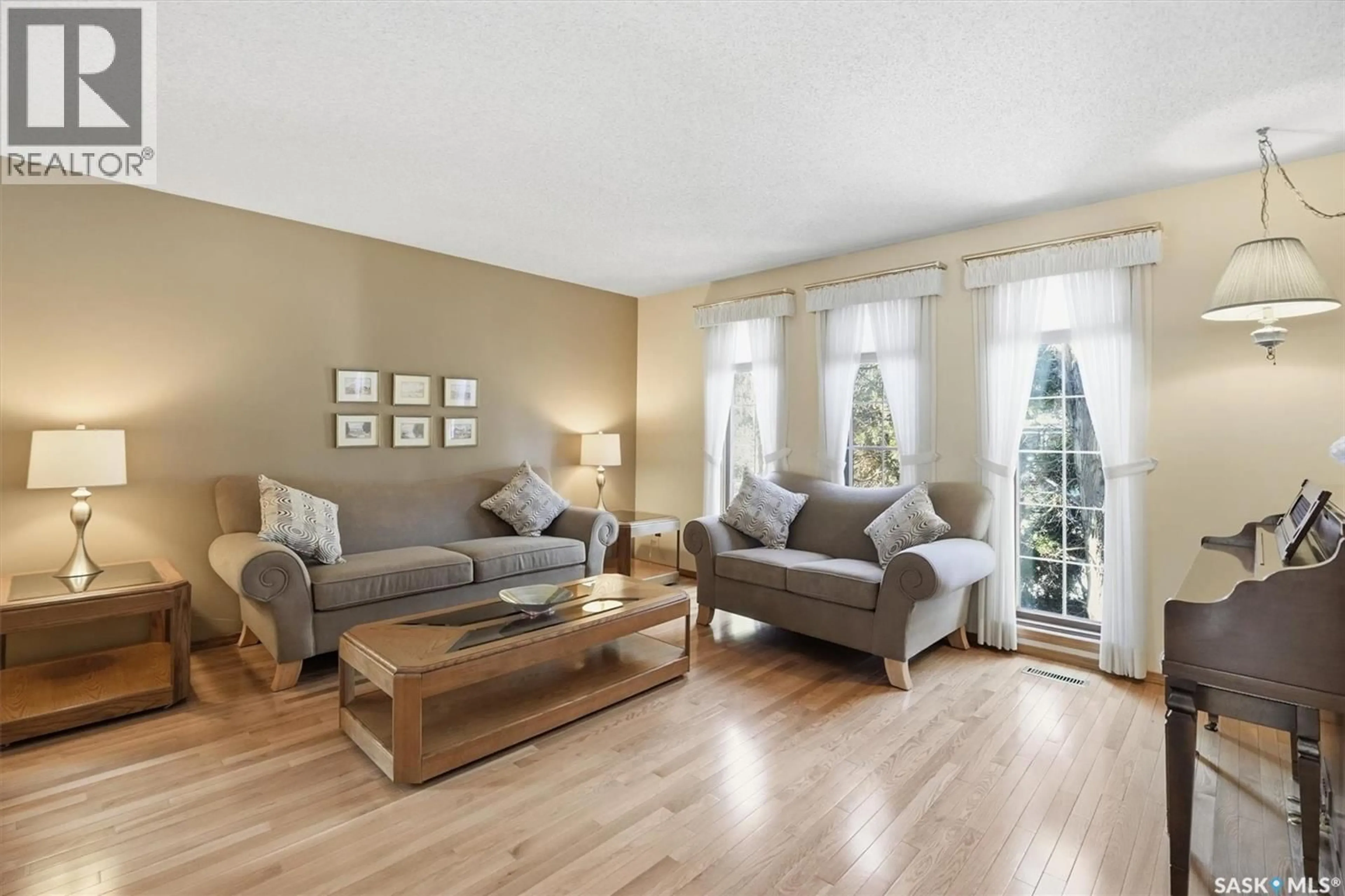 Living room with furniture, wood/laminate floor for 458 CHARLEBOIS TERRACE, Saskatoon Saskatchewan S7K5K1