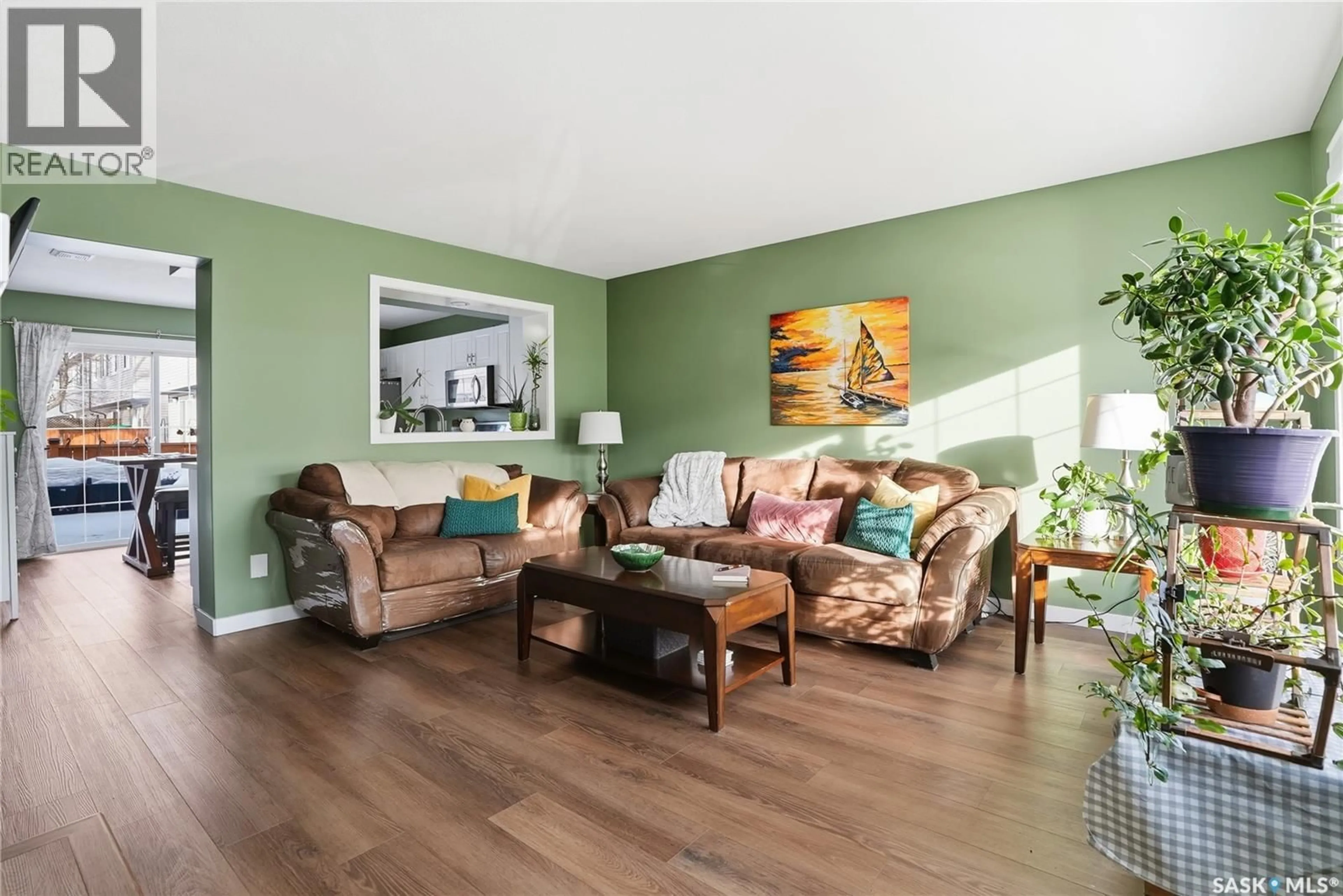 Living room with furniture, wood/laminate floor for 670 - 225 KENDERDINE ROAD, Saskatoon Saskatchewan S7N4W4