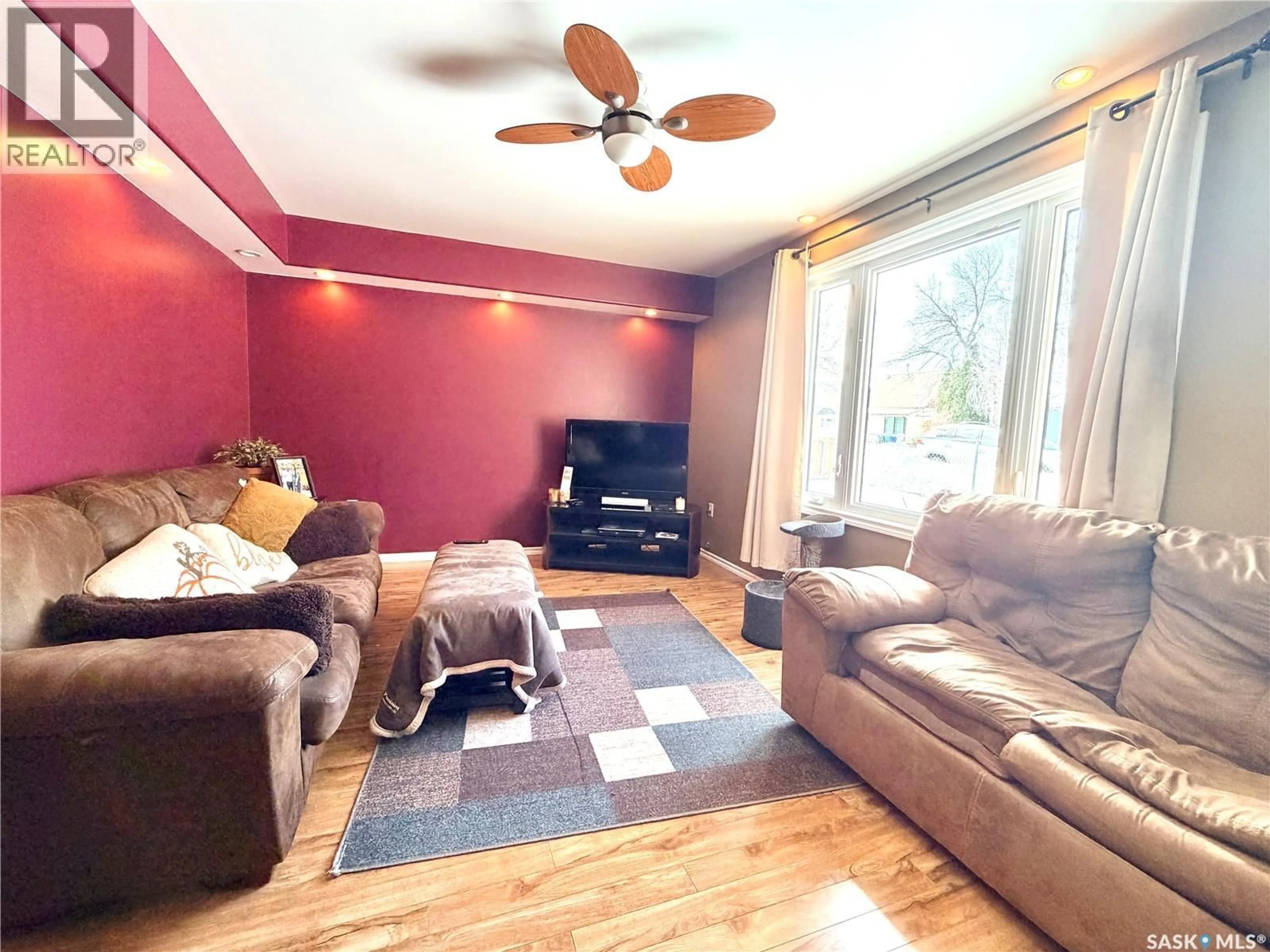 Living room with furniture, wood/laminate floor for 1382 107TH STREET, North Battleford Saskatchewan S9A1Z7