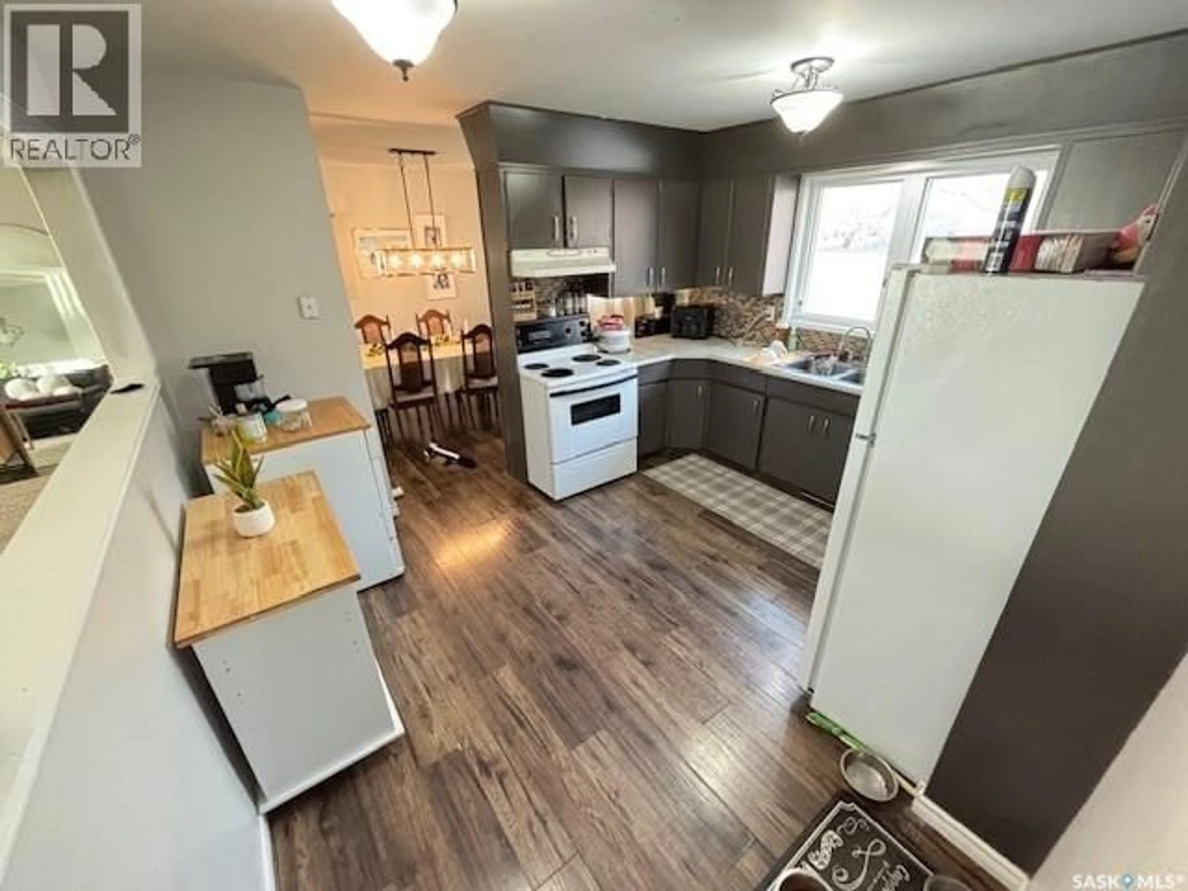 Open concept kitchen, wood/laminate floor for 1446 STADACONA STREET, Moose Jaw Saskatchewan S6H6R9