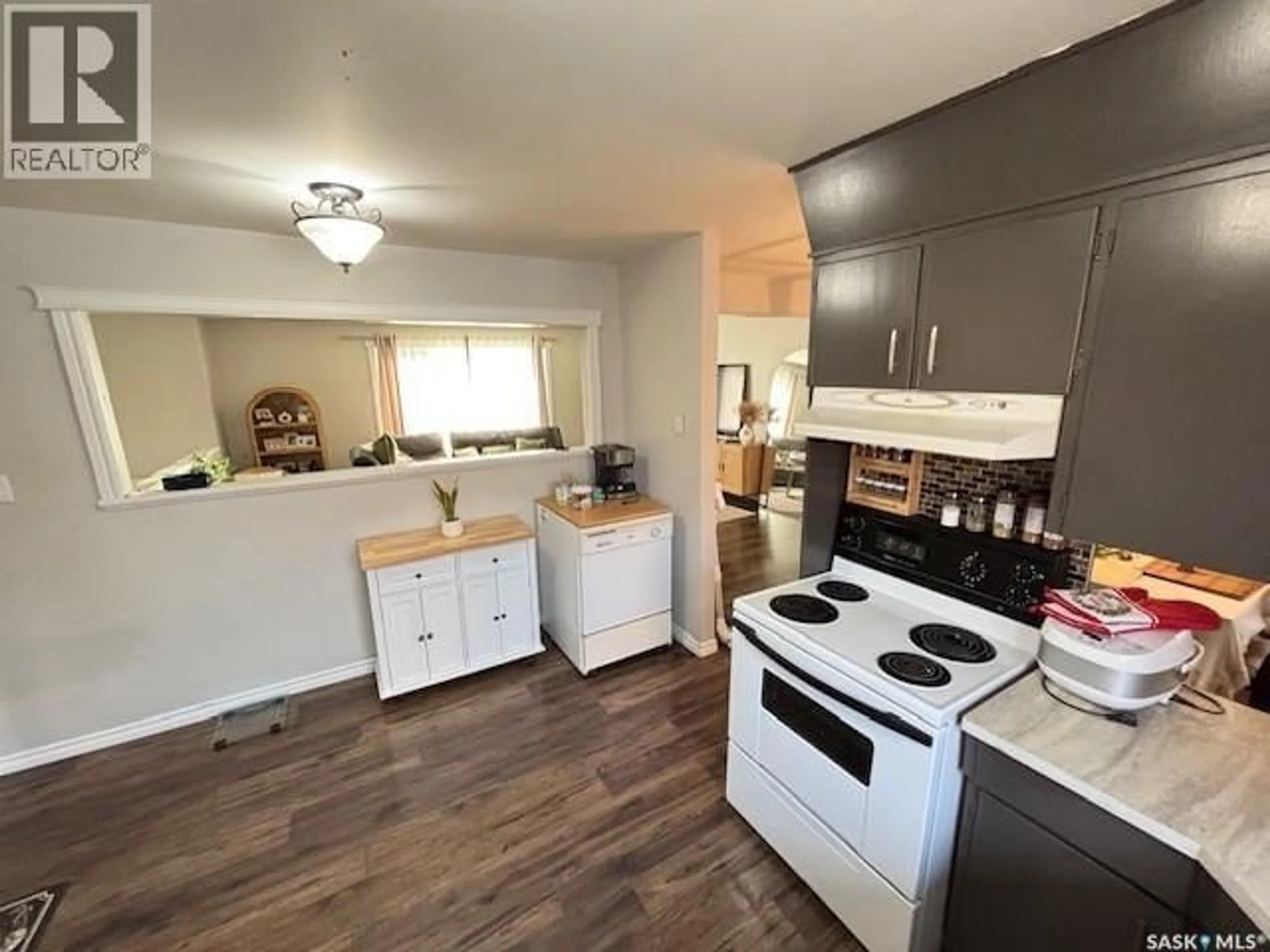 Open concept kitchen, wood/laminate floor for 1446 STADACONA STREET, Moose Jaw Saskatchewan S6H6R9