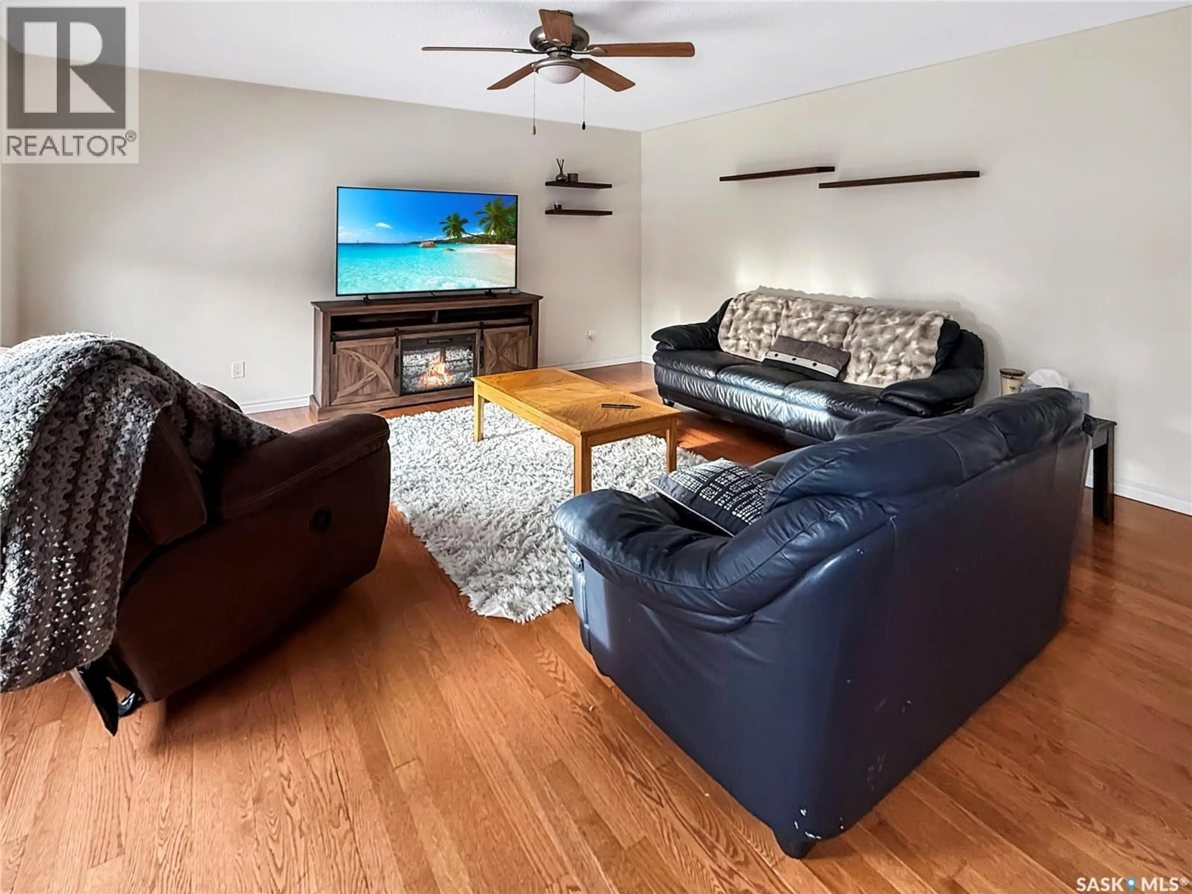 Living room with furniture, wood/laminate floor for 372 HAYES DRIVE, Swift Current Saskatchewan S9H4H1