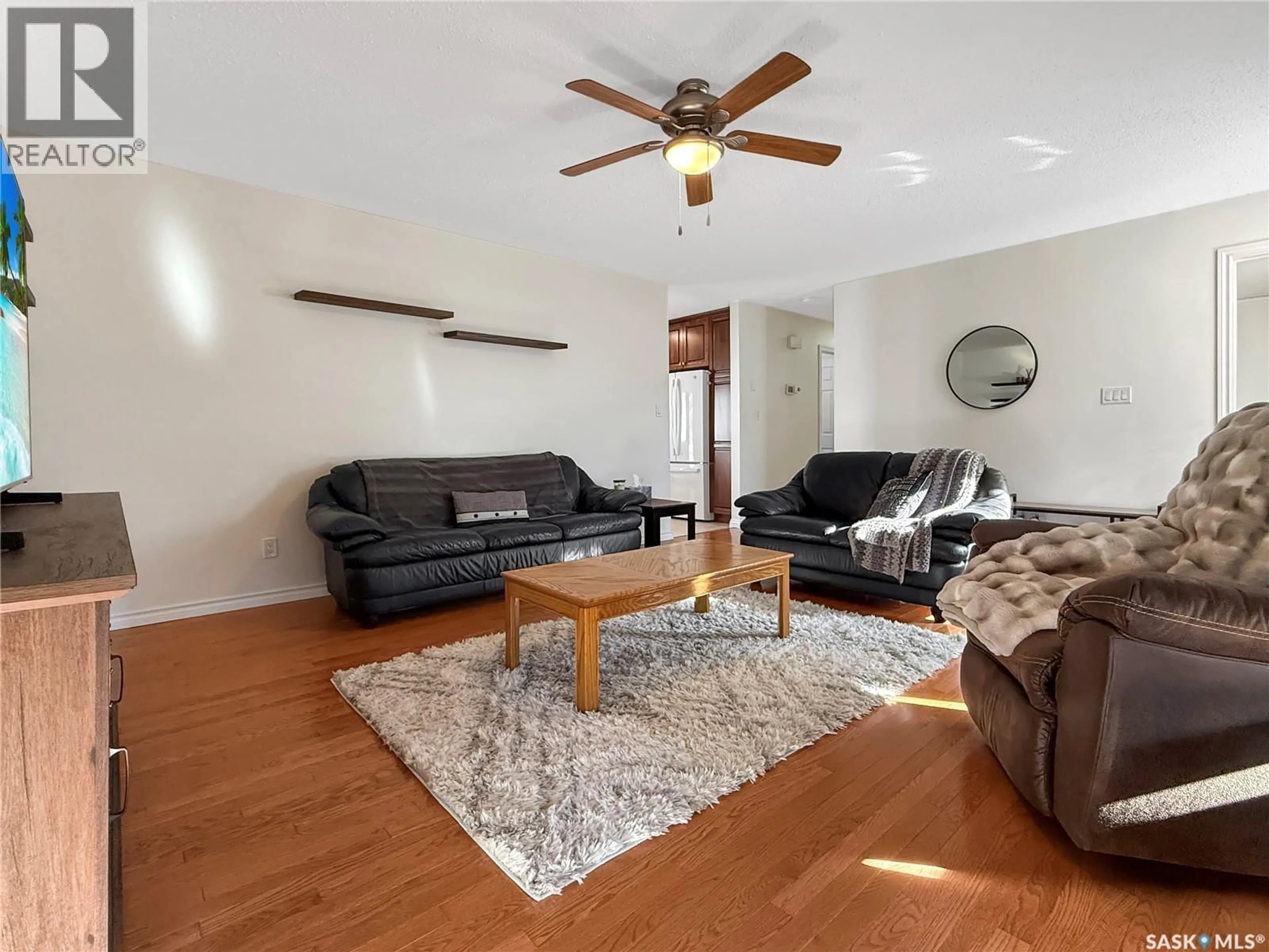 Living room with furniture, wood/laminate floor for 372 HAYES DRIVE, Swift Current Saskatchewan S9H4H1