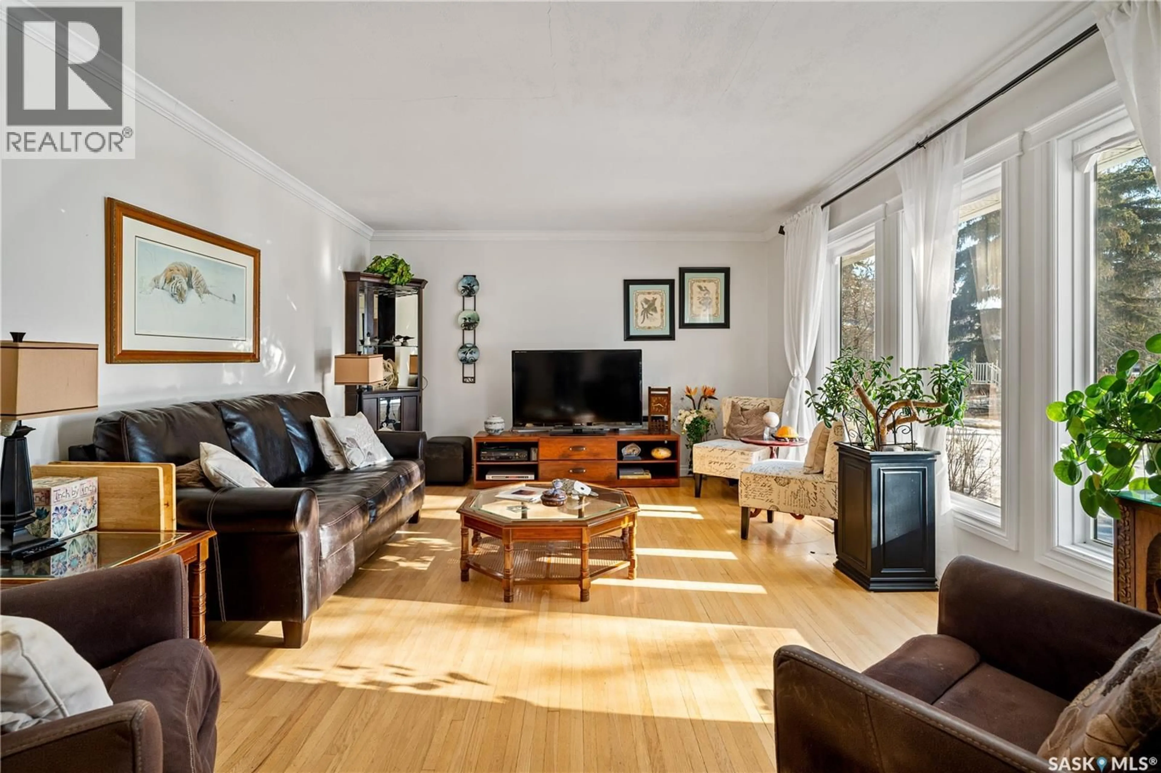 Living room with furniture, wood/laminate floor for 5024 1ST AVENUE, Regina Saskatchewan S4T0A5