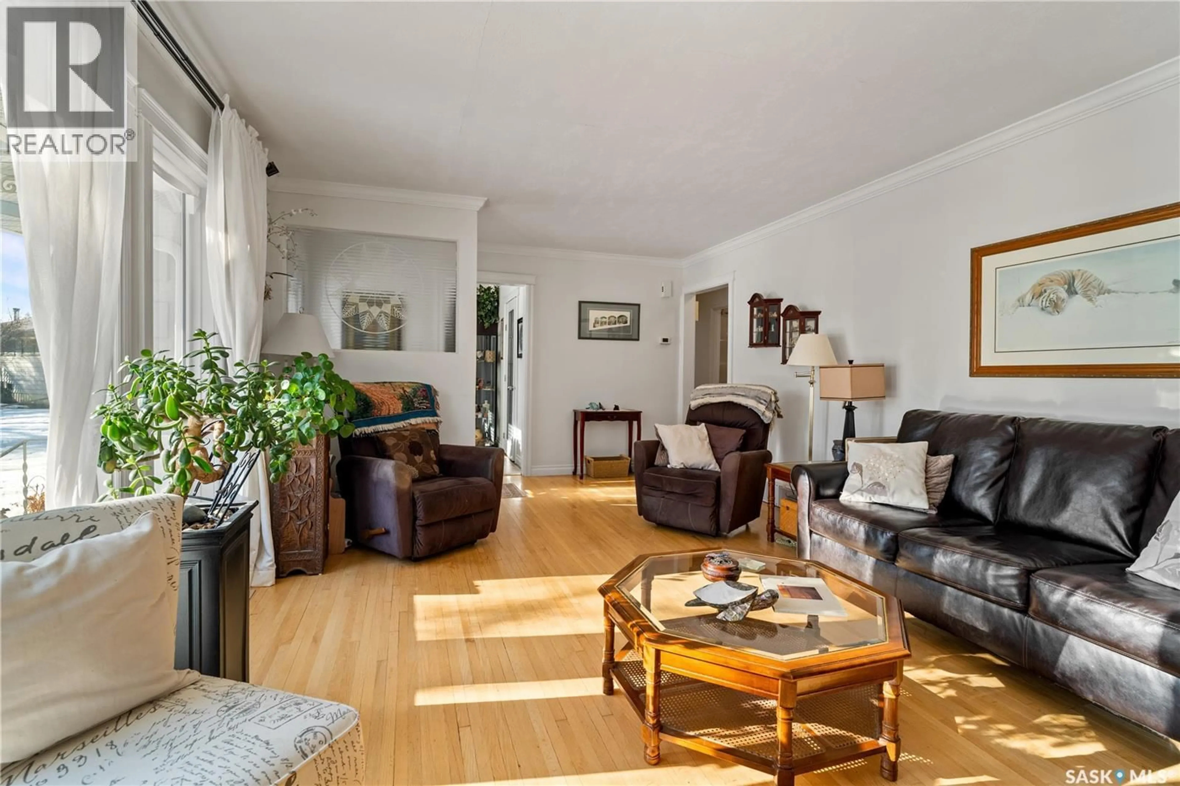 Living room with furniture, wood/laminate floor for 5024 1ST AVENUE, Regina Saskatchewan S4T0A5