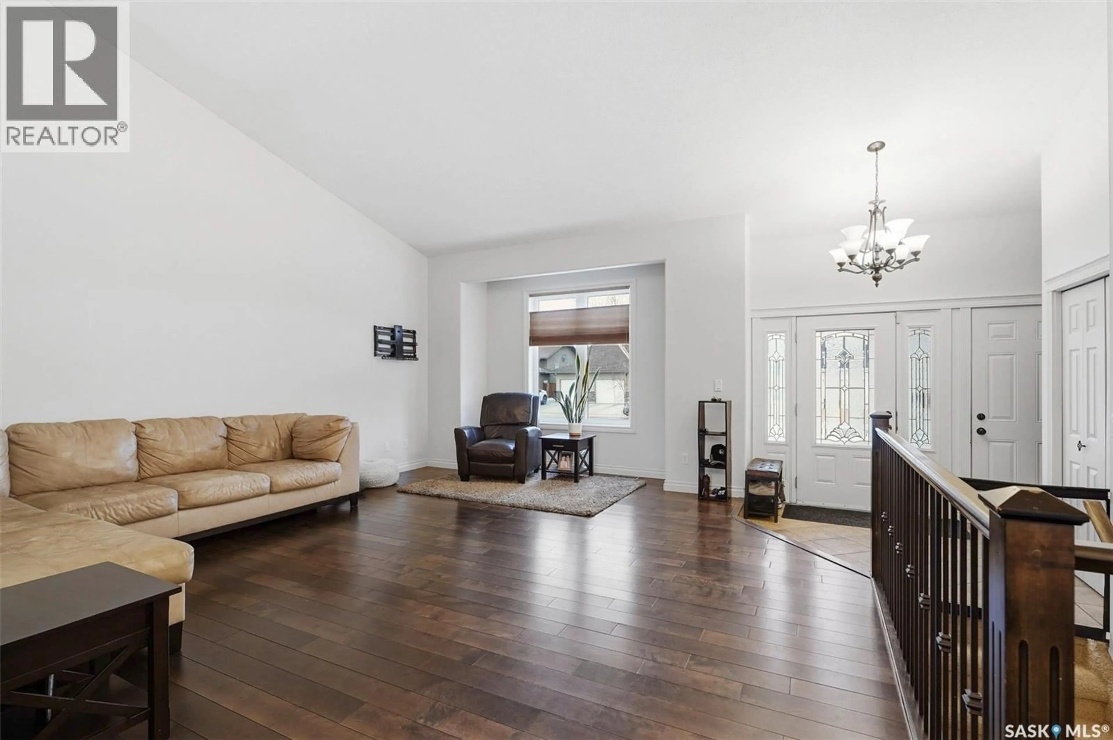 Living room with furniture, wood/laminate floor for 810 ROCK HILL LANE, Martensville Saskatchewan S0K0A2