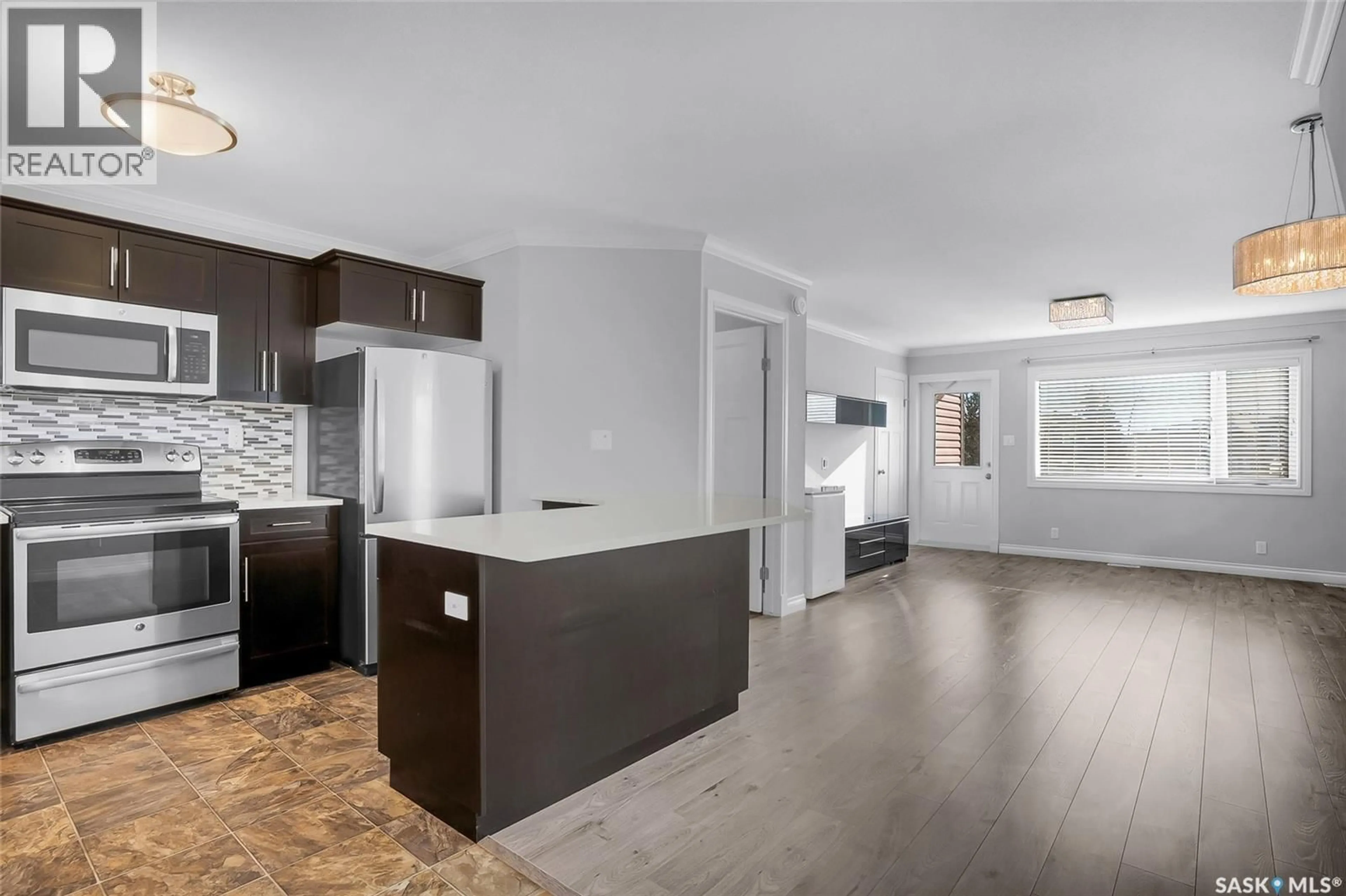 Open concept kitchen, wood/laminate floor for 102 - 110 MANEK ROAD, Saskatoon Saskatchewan S7W0V2