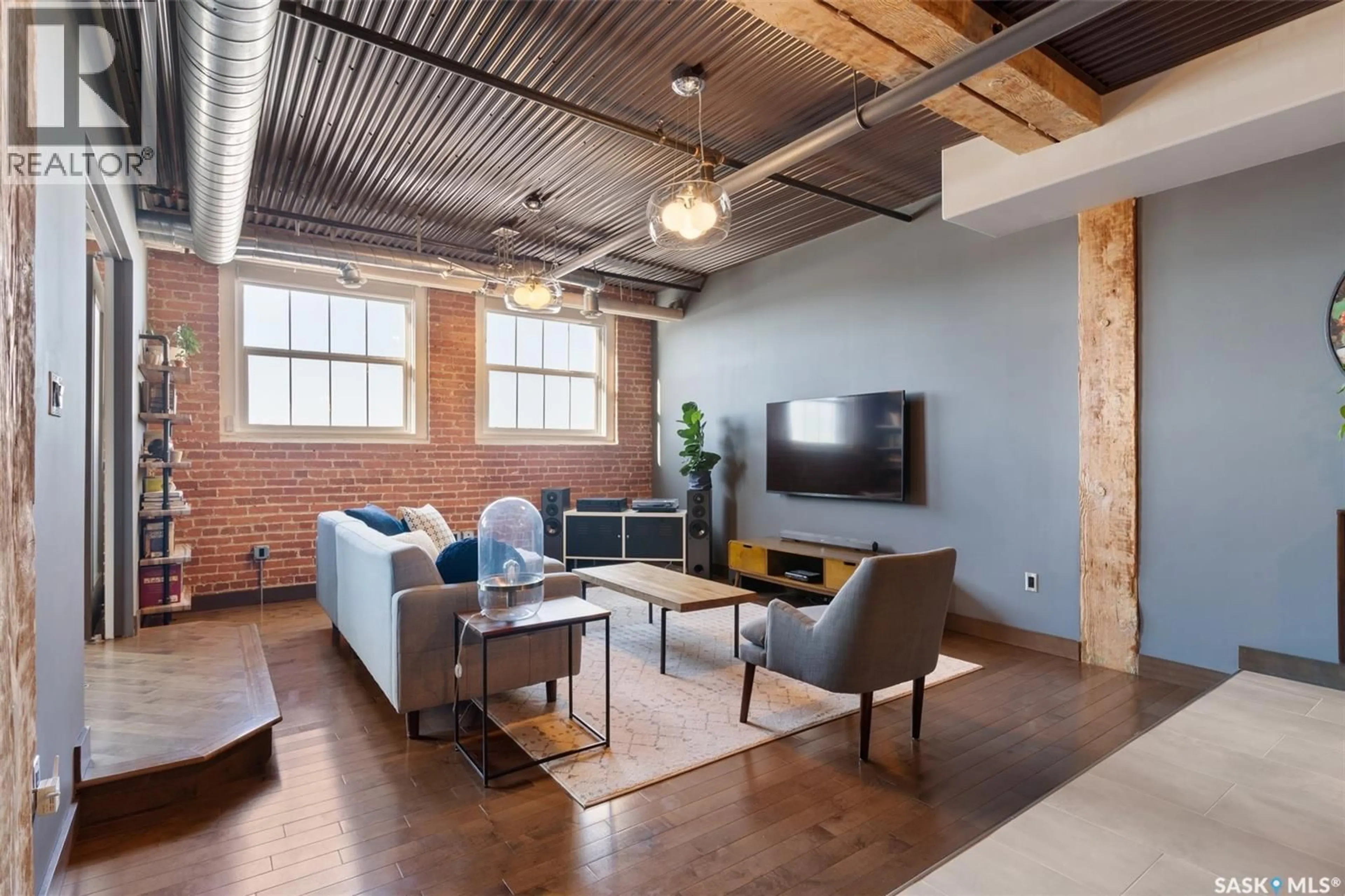 Living room with furniture, cement floor for 305 - 1275 BROAD STREET, Regina Saskatchewan S4R1Y2