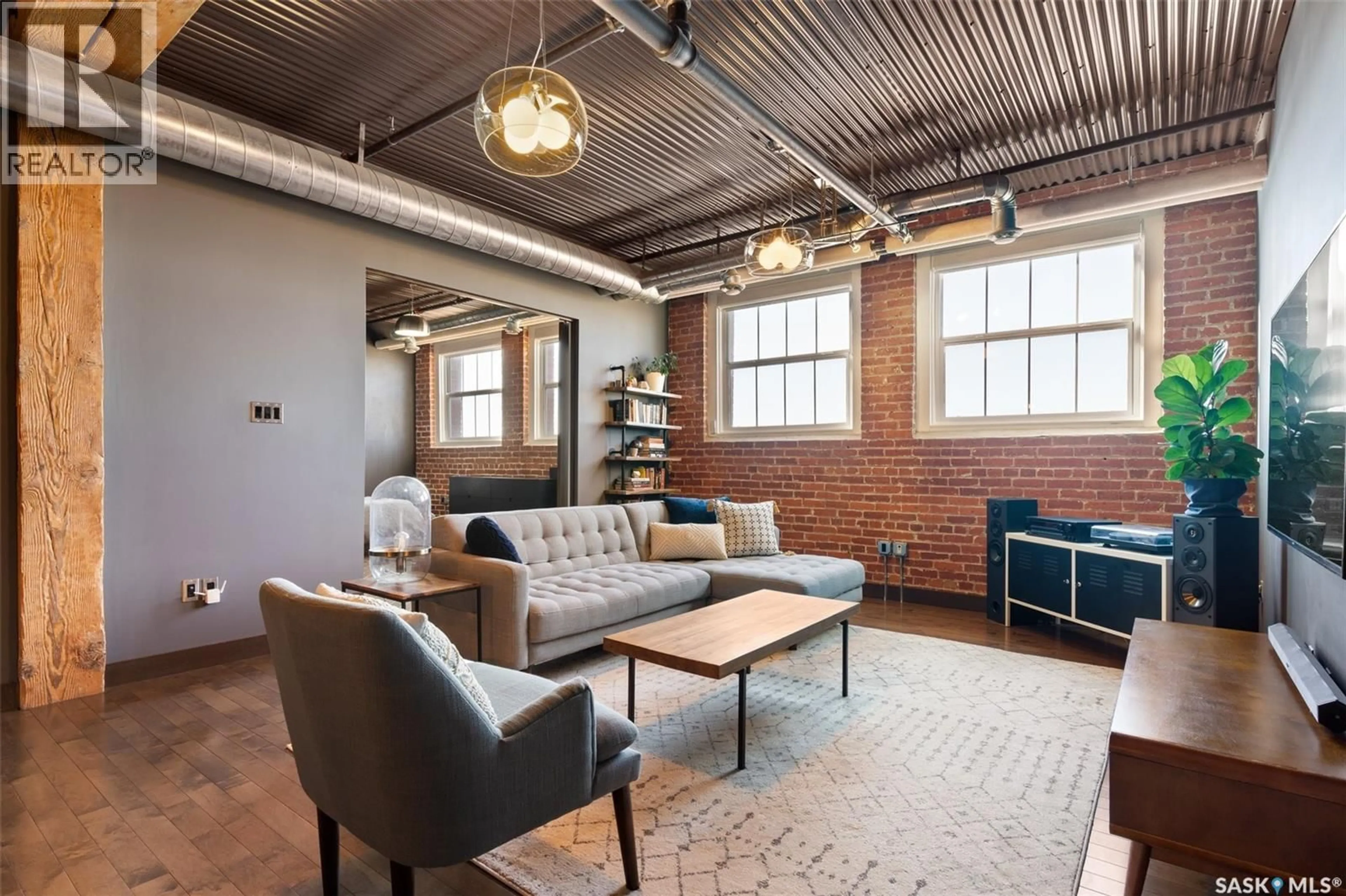 Living room with furniture, cement floor for 305 - 1275 BROAD STREET, Regina Saskatchewan S4R1Y2