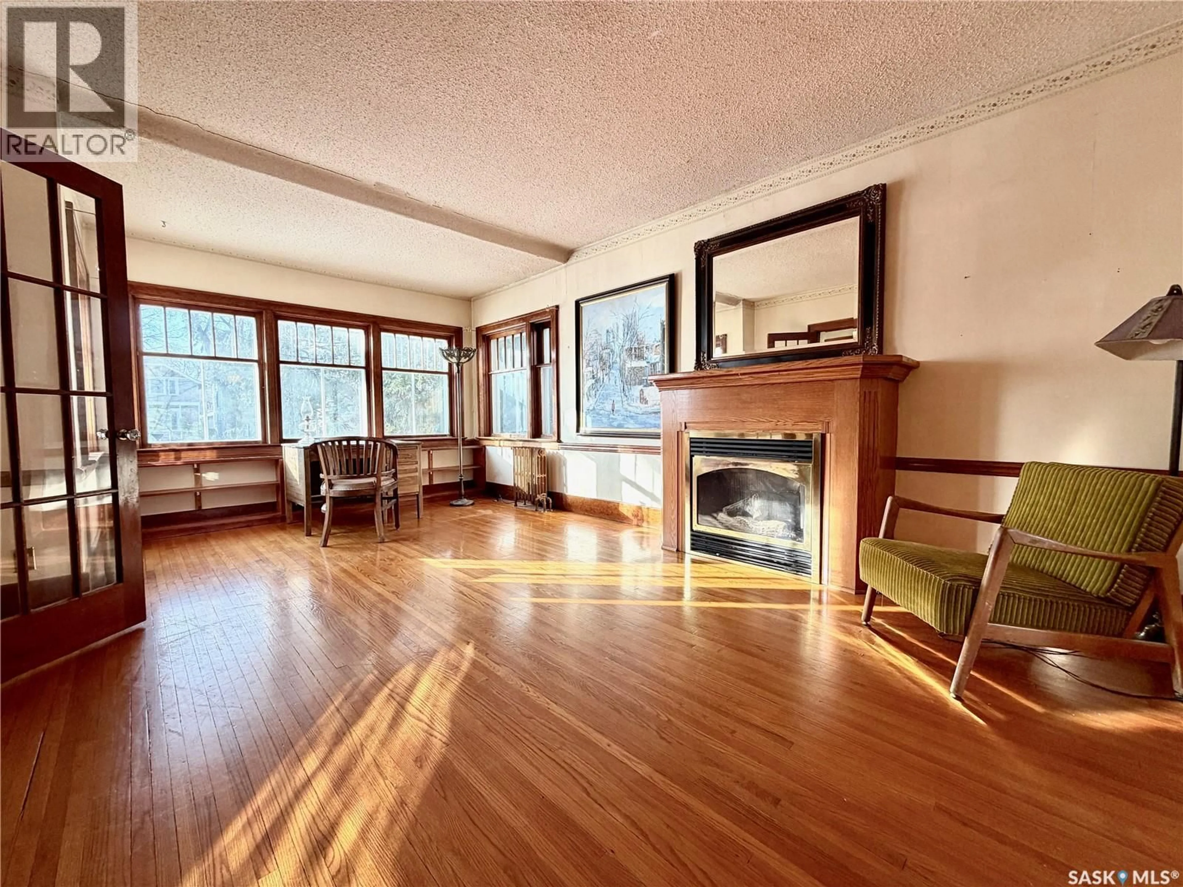 Living room with furniture, wood/laminate floor for 304 32ND STREET, Saskatoon Saskatchewan S7L0S6