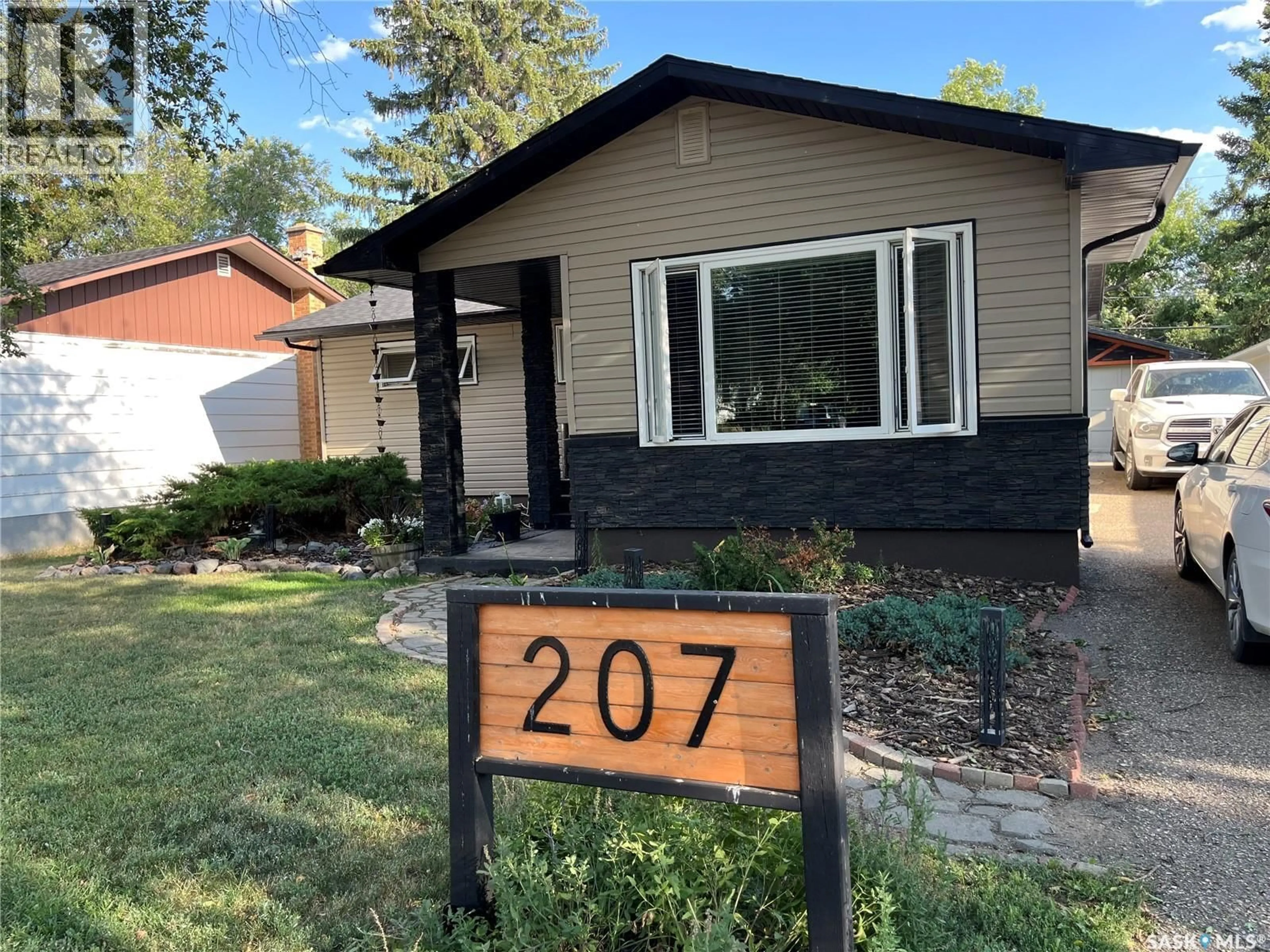 Home with vinyl exterior material, street for 207 DOMINION ROAD, Assiniboia Saskatchewan S0H0B0