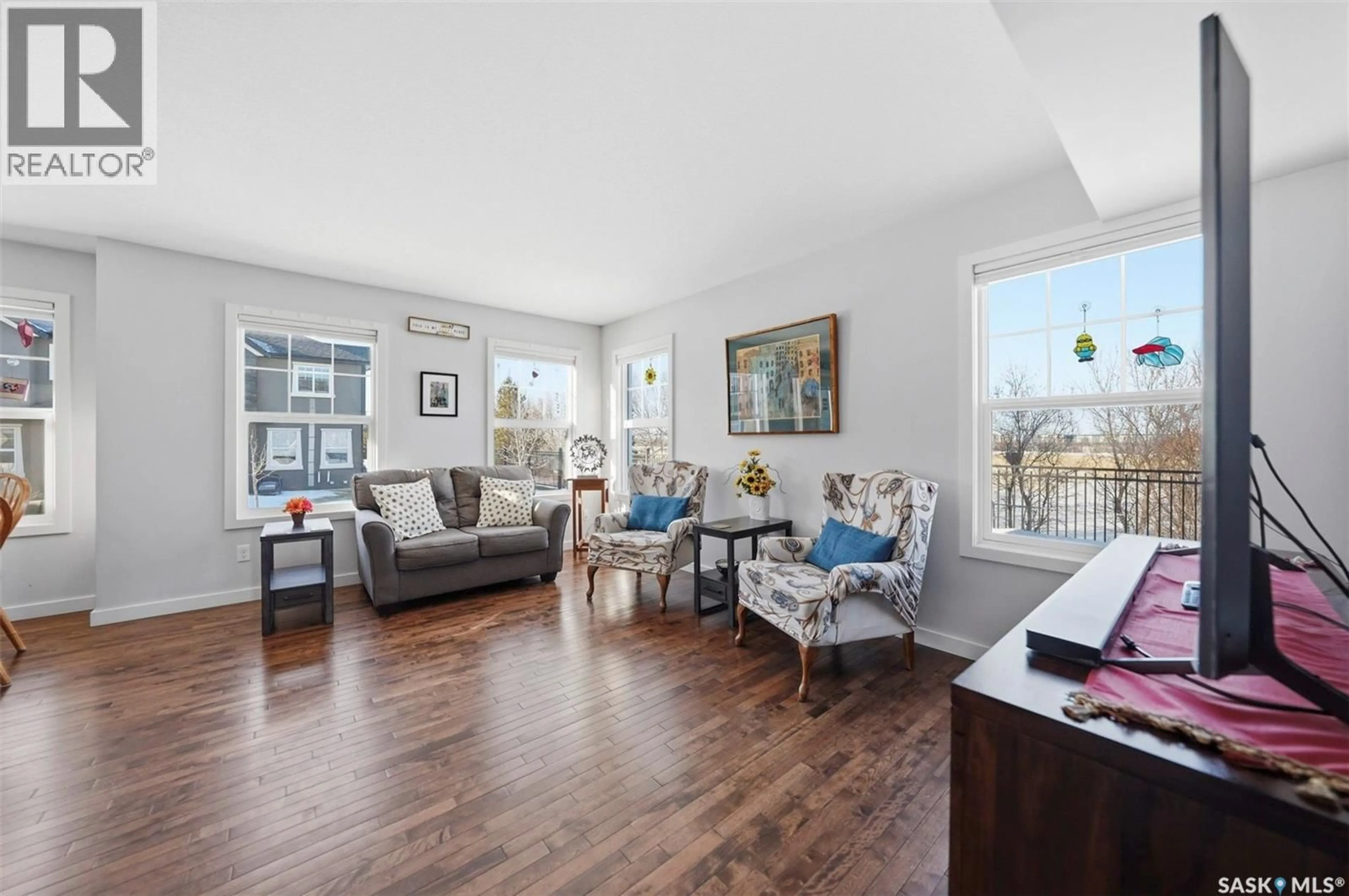 Living room with furniture, wood/laminate floor for 501 1303 PATON CRESCENT, Saskatoon Saskatchewan S7W0P7