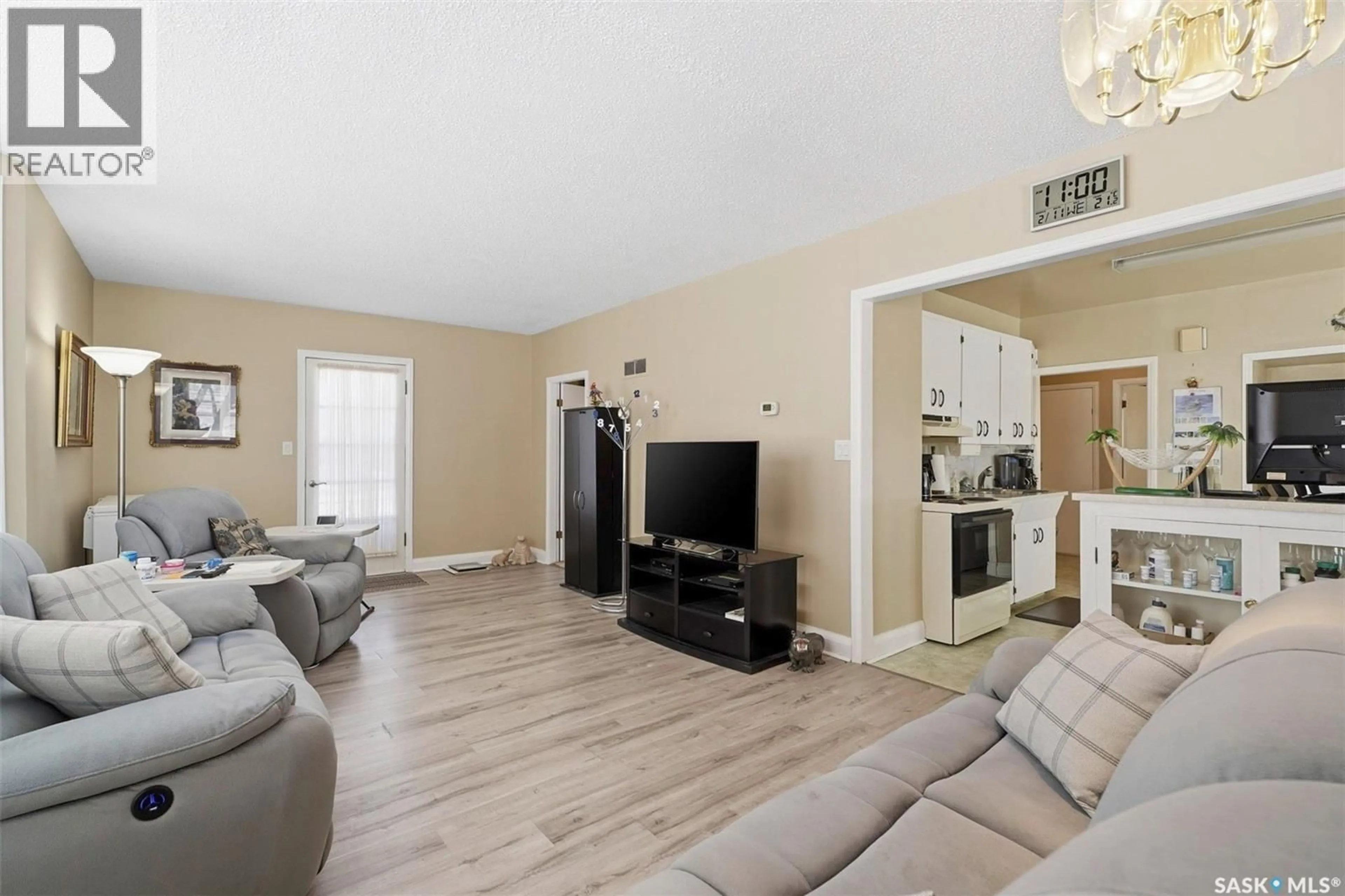 Living room with furniture, wood/laminate floor for 208 2ND AVENUE E, Nokomis Saskatchewan S0G3R0