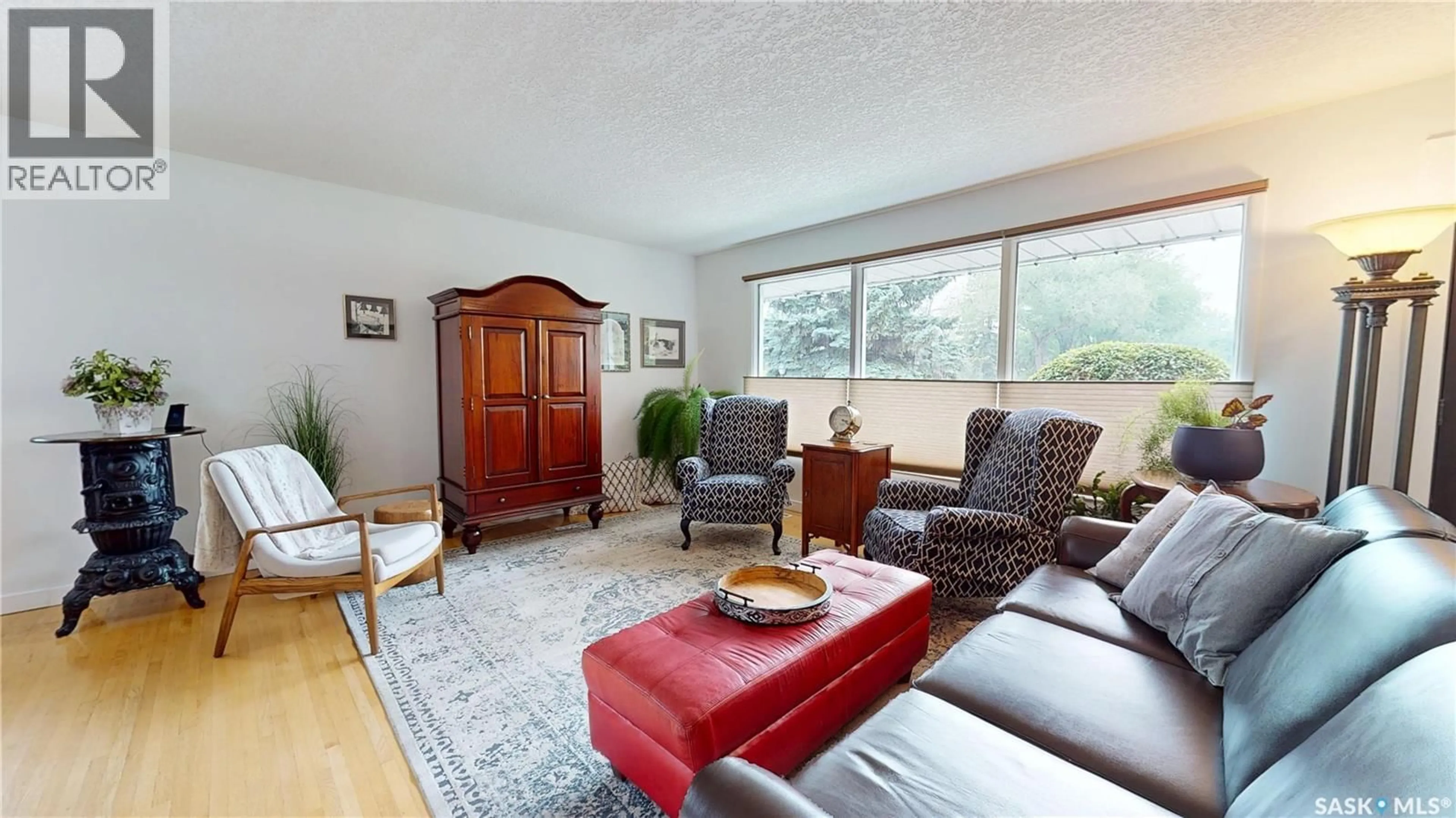 Living room with furniture, wood/laminate floor for 29 LATTA STREET, Regina Saskatchewan S4S3Y2