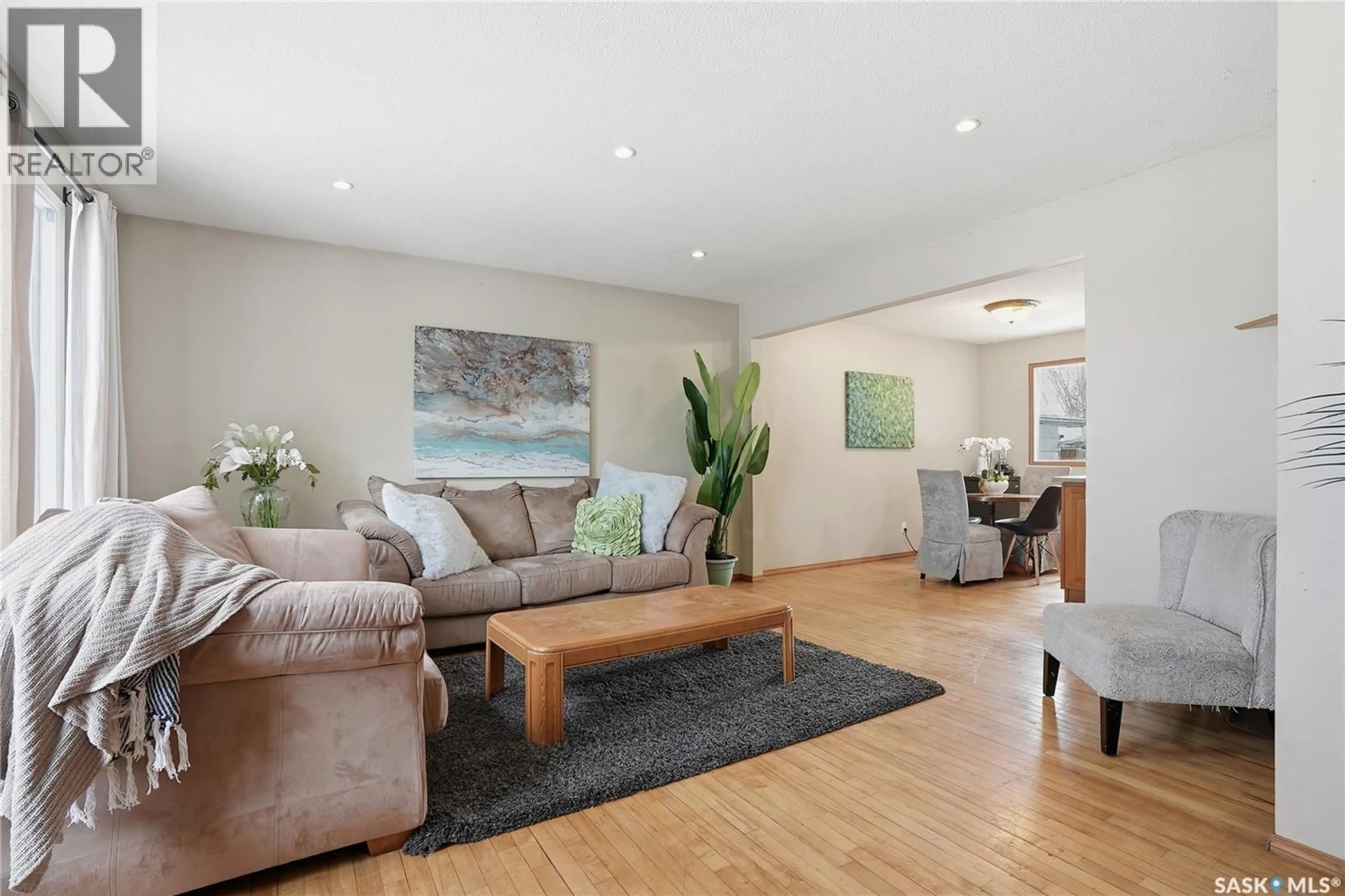 Living room with furniture, wood/laminate floor for 285 CARLETON DRIVE, Saskatoon Saskatchewan S7H3P1