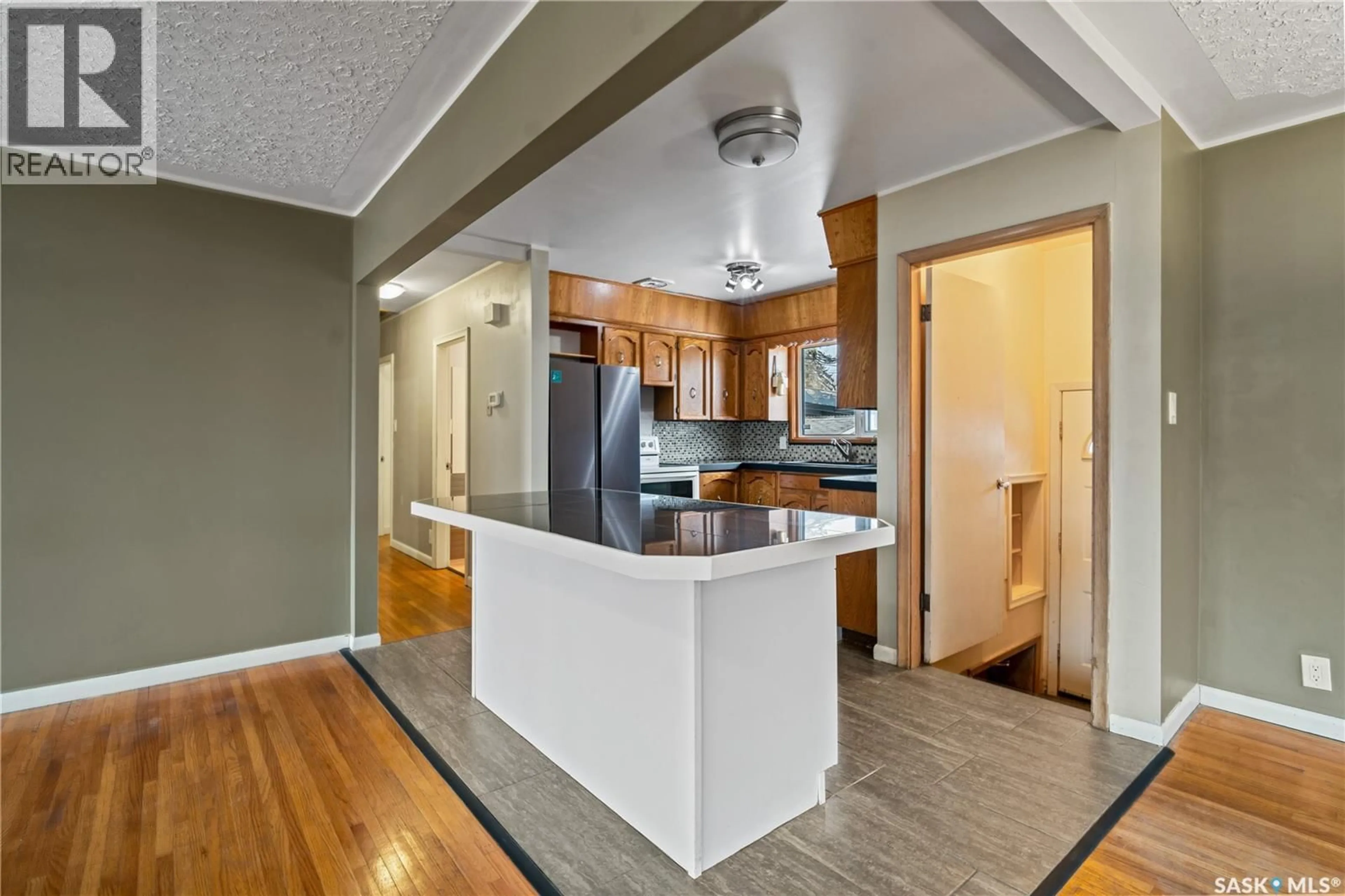 Open concept kitchen, wood/laminate floor for 5306 5TH AVENUE, Regina Saskatchewan S4T0M4