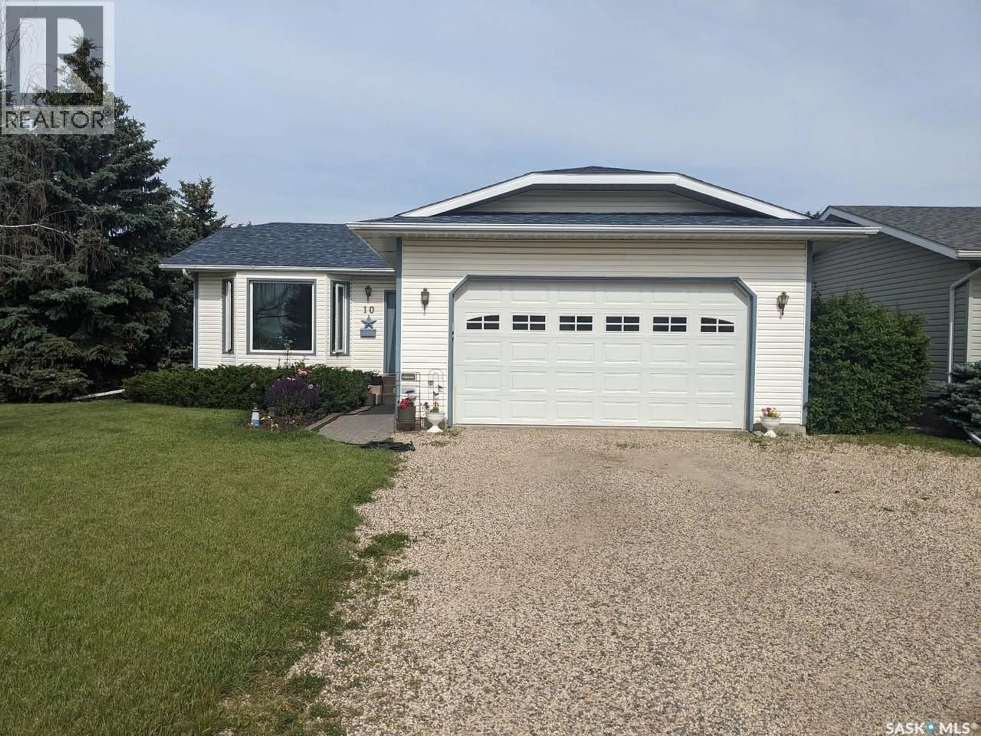 Home with vinyl exterior material, street for 10 MEADOWS PLACE, Watrous Saskatchewan S0K4T0