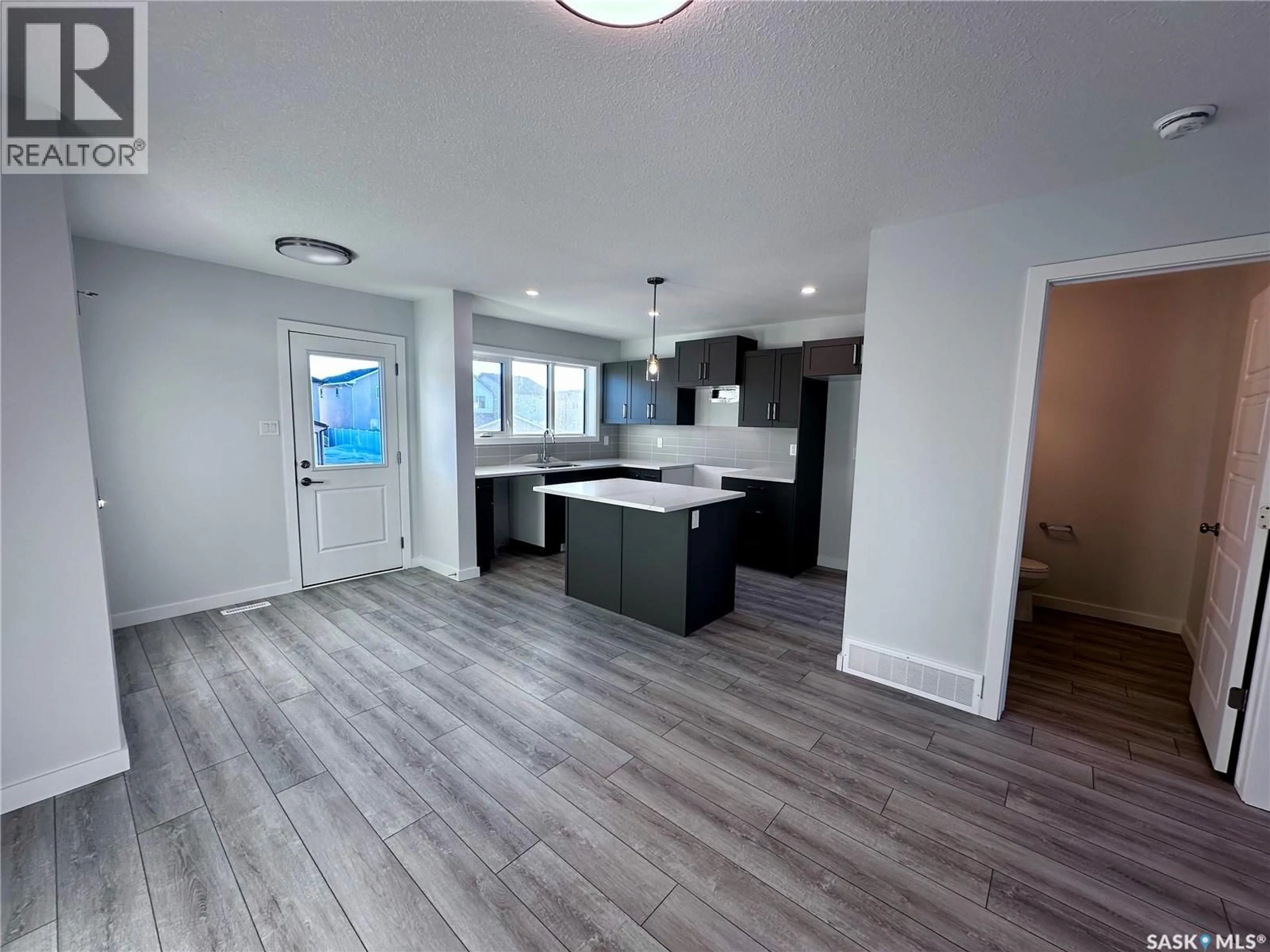 Open concept kitchen, wood/laminate floor for 5449 BUCKINGHAM DRIVE, Regina Saskatchewan S4V4B5