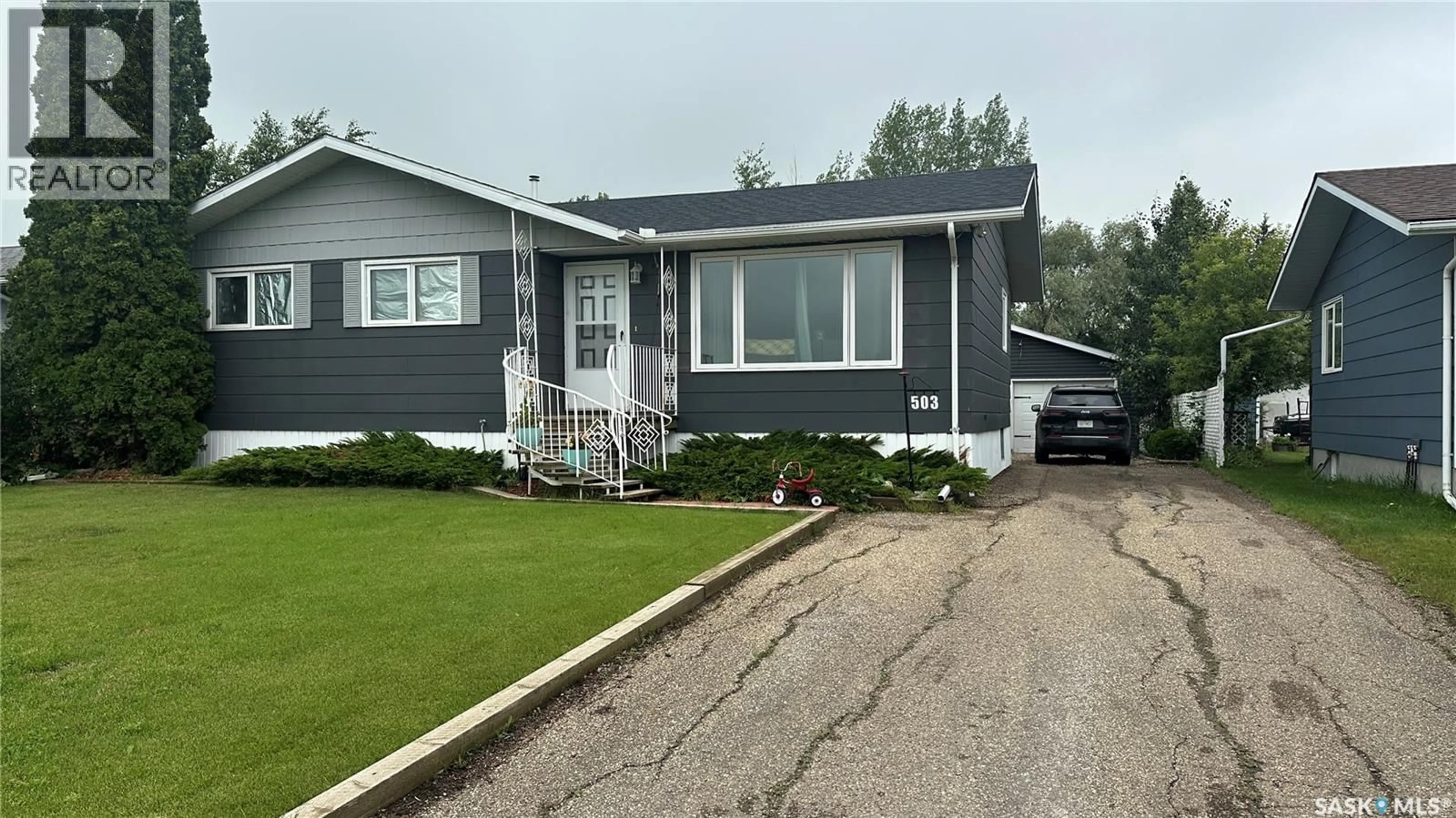 Home with vinyl exterior material, street for 503 103RD AVENUE, Tisdale Saskatchewan S0E1T0