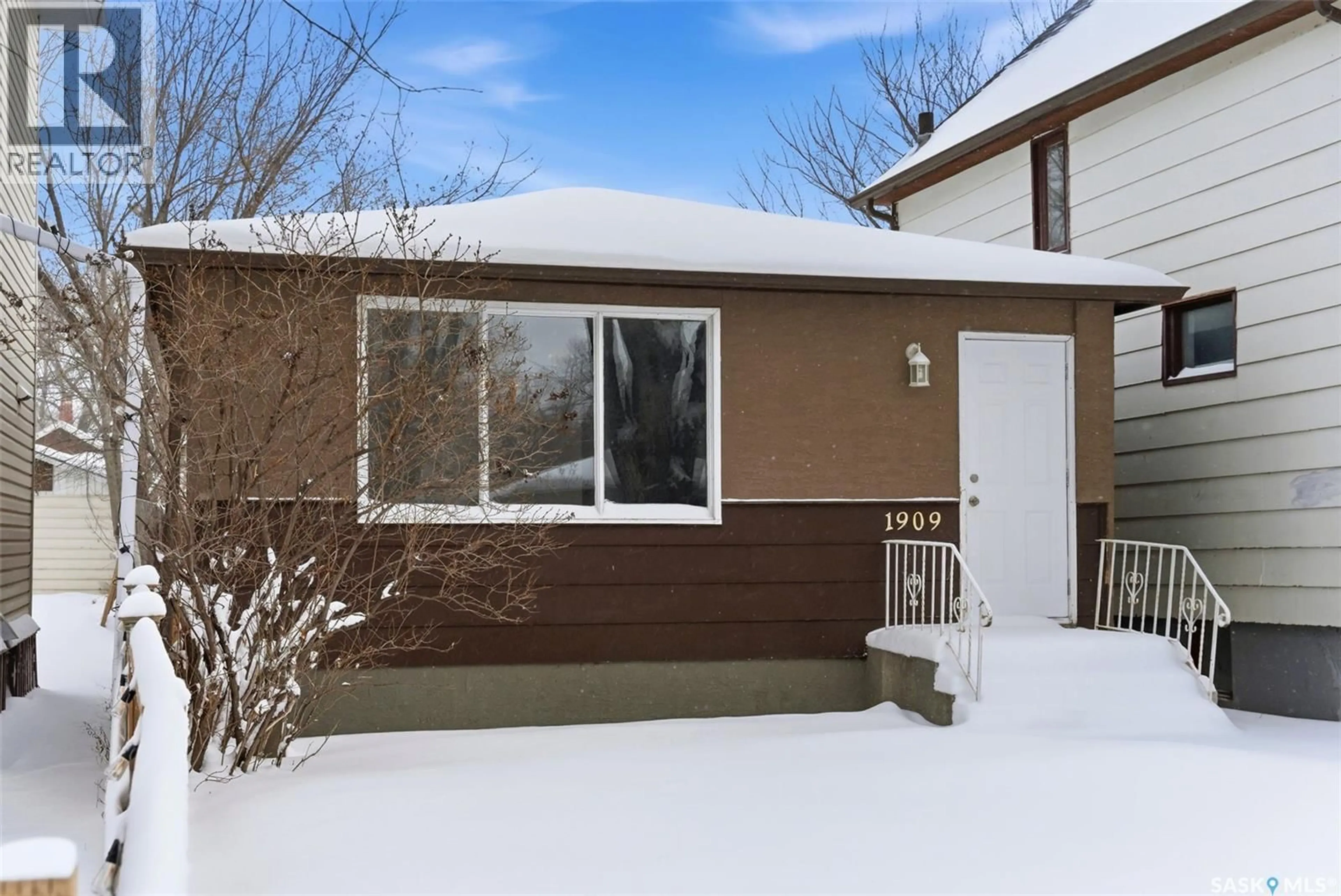 Home with vinyl exterior material, street for 1909 MONTREAL STREET, Regina Saskatchewan S4P1L4