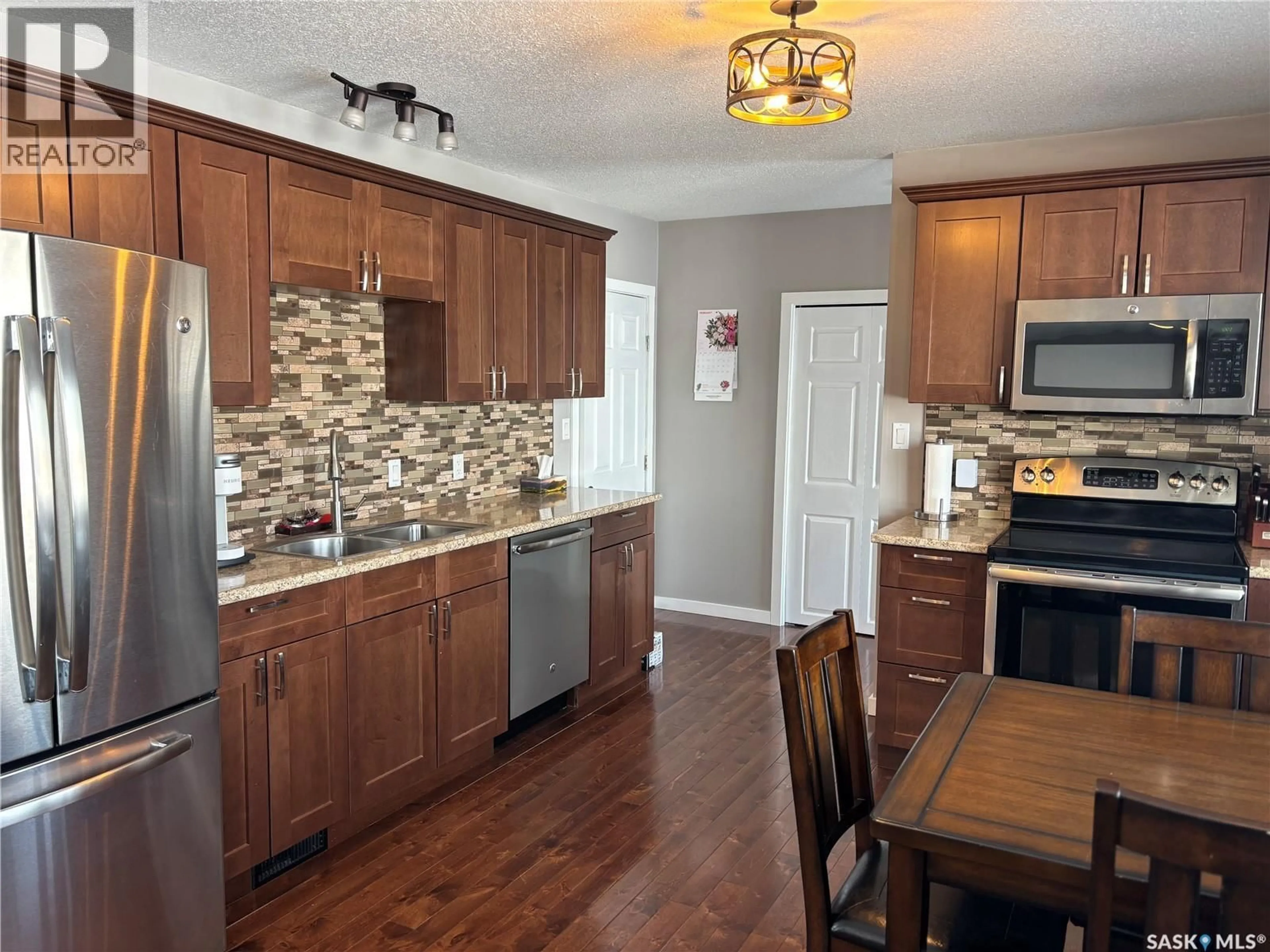 Open concept kitchen, wood/laminate floor for 1003 11TH STREET, Humboldt Saskatchewan S0K2A0