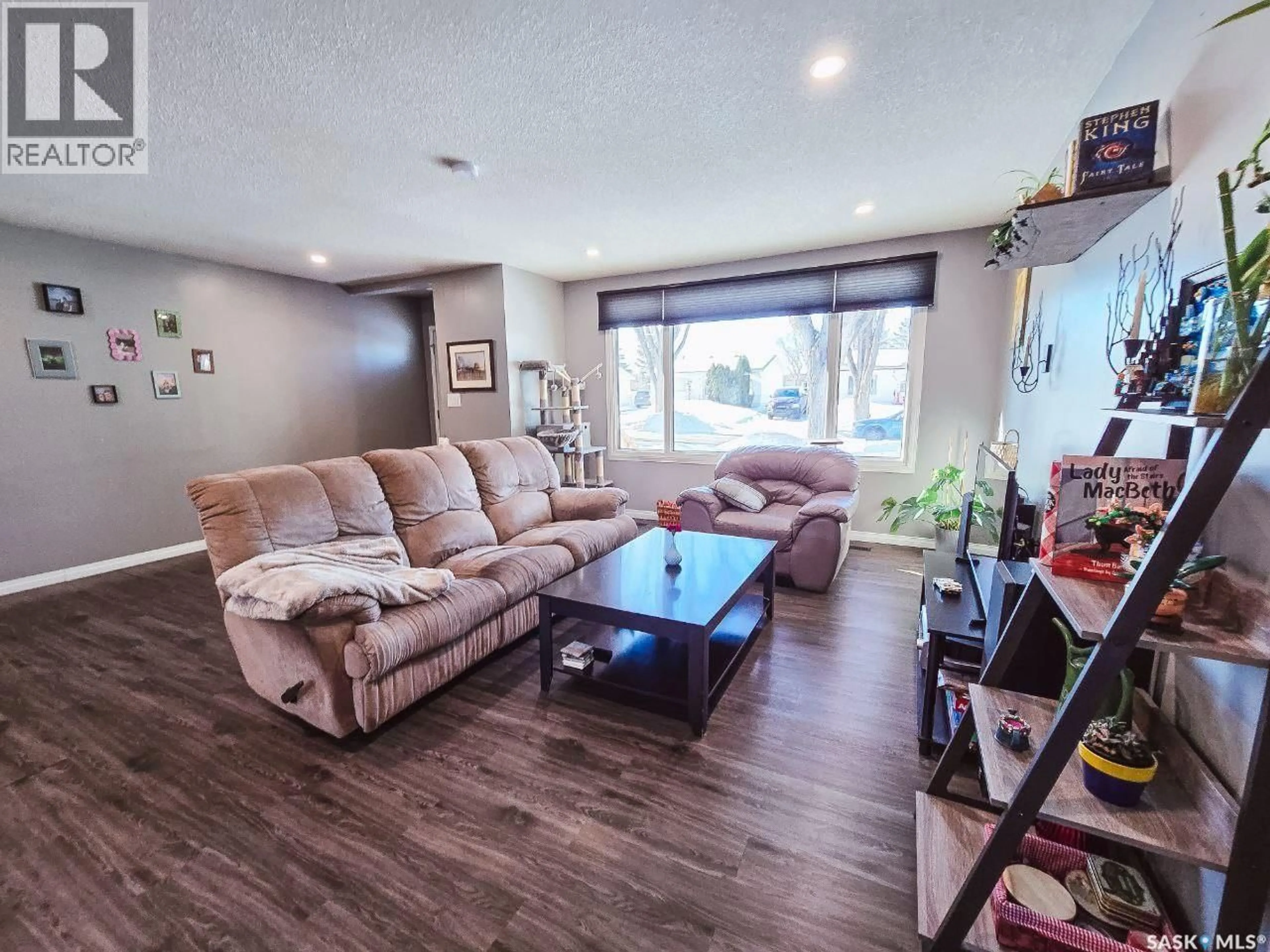 Living room with furniture, wood/laminate floor for 211 EIGHTH AVENUE, Yorkton Saskatchewan S3N0W8