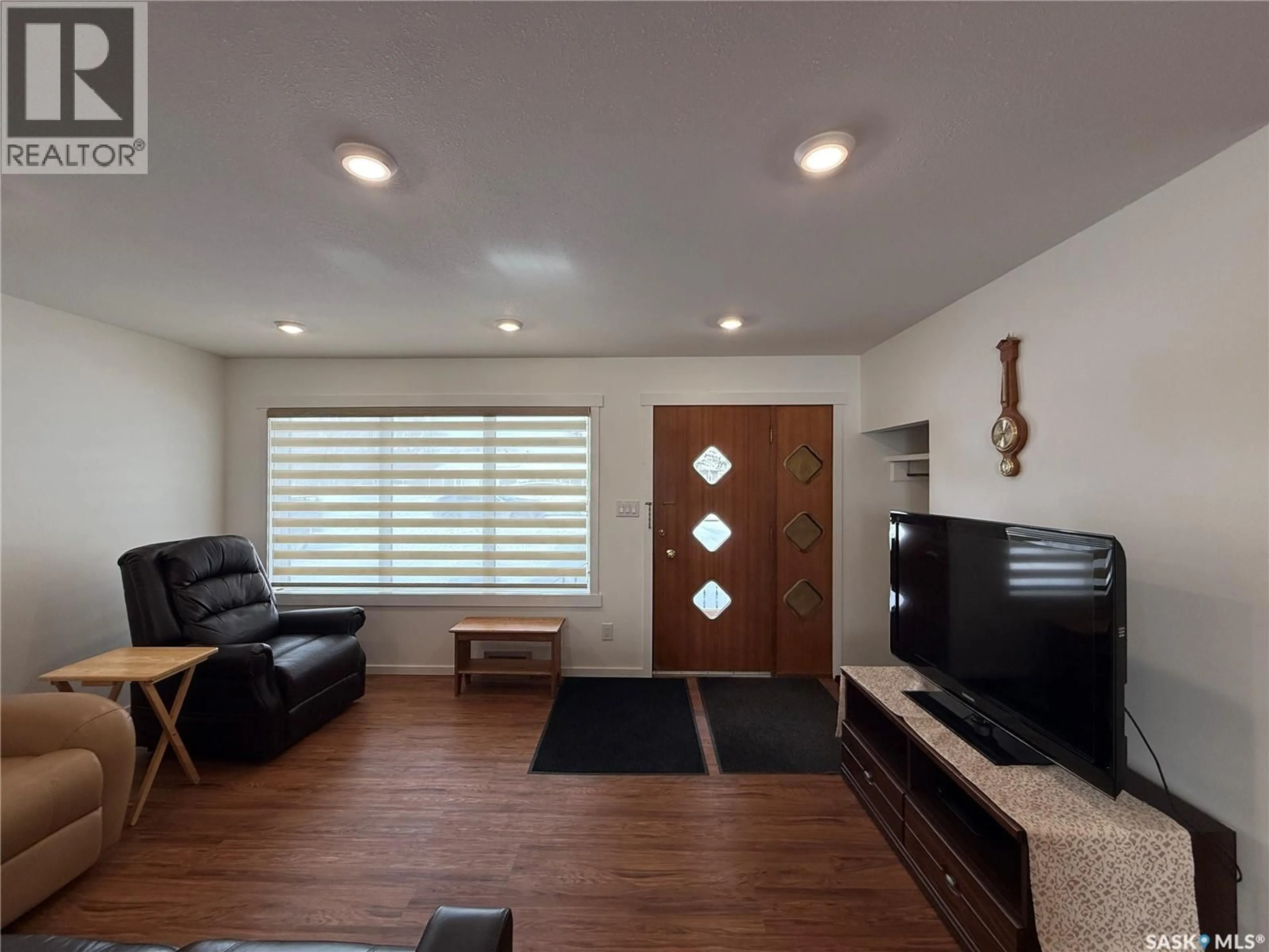 Living room with furniture, wood/laminate floor for 19 SASKATCHEWAN AVENUE, Quill Lake Saskatchewan S0A3E0