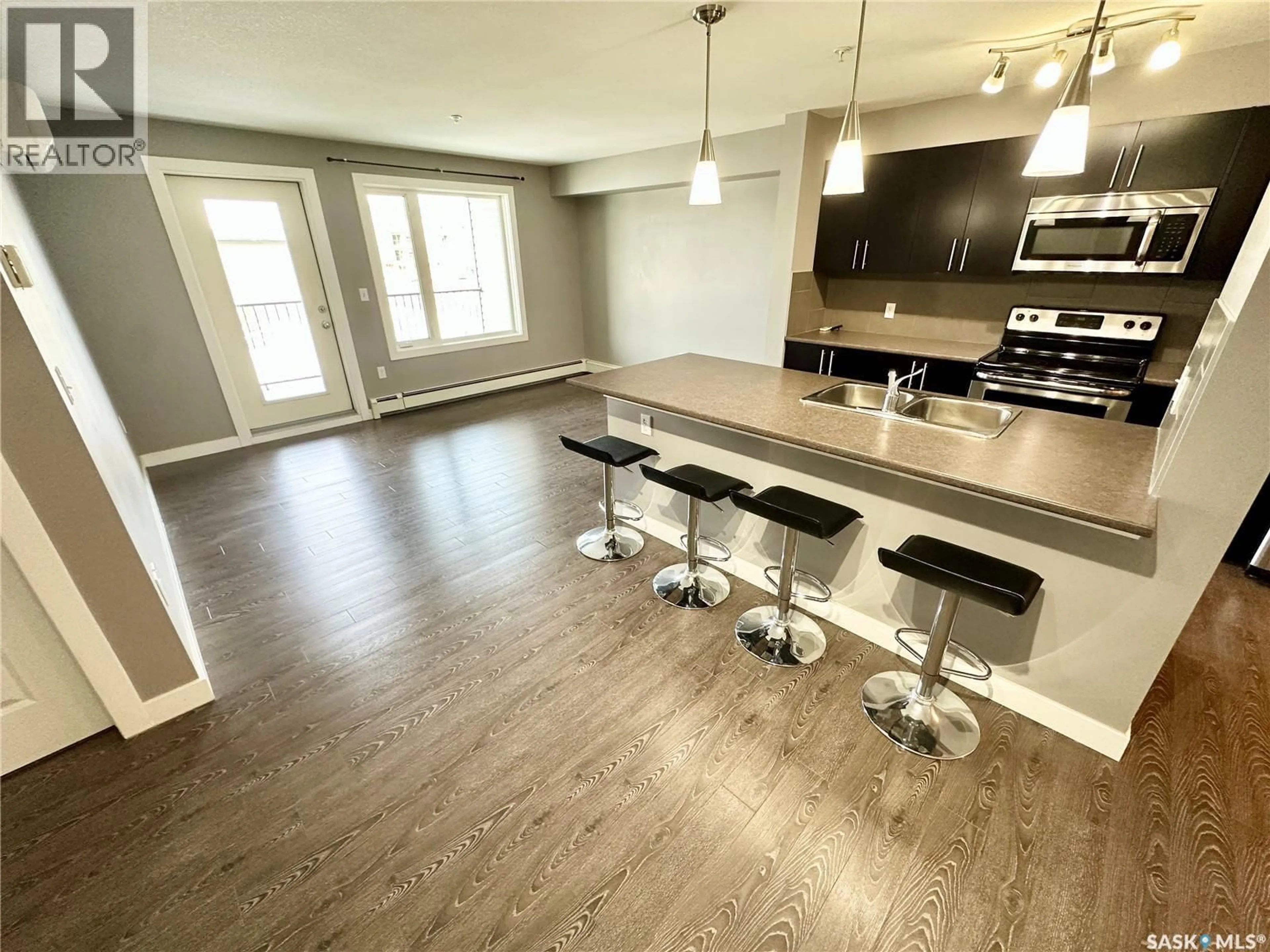 Open concept kitchen, wood/laminate floor for NE - 202 820 5TH STREET, Weyburn Saskatchewan S4H2V2