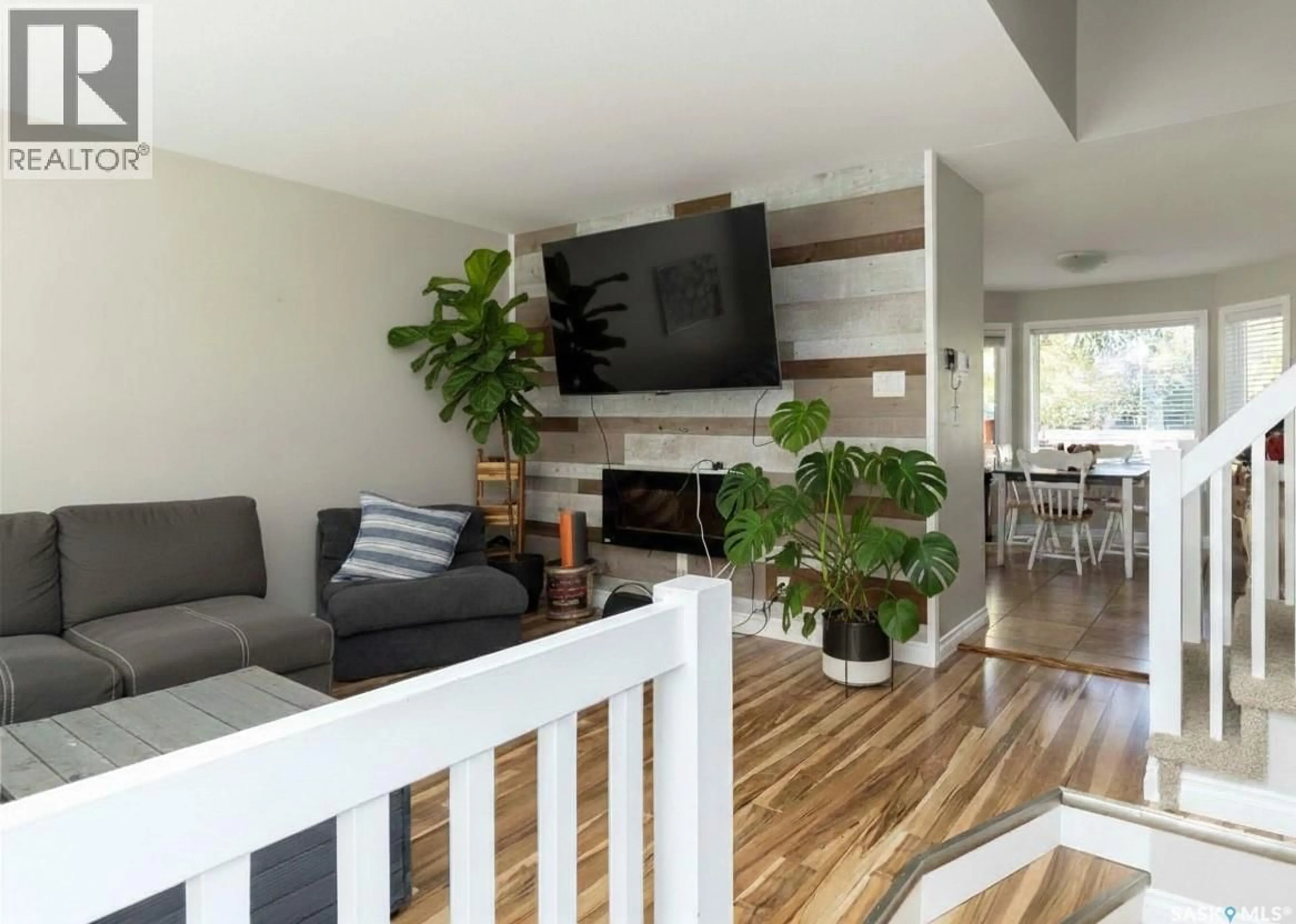 Living room with furniture, wood/laminate floor for 418 KENDERDINE ROAD, Saskatoon Saskatchewan S7N3S1