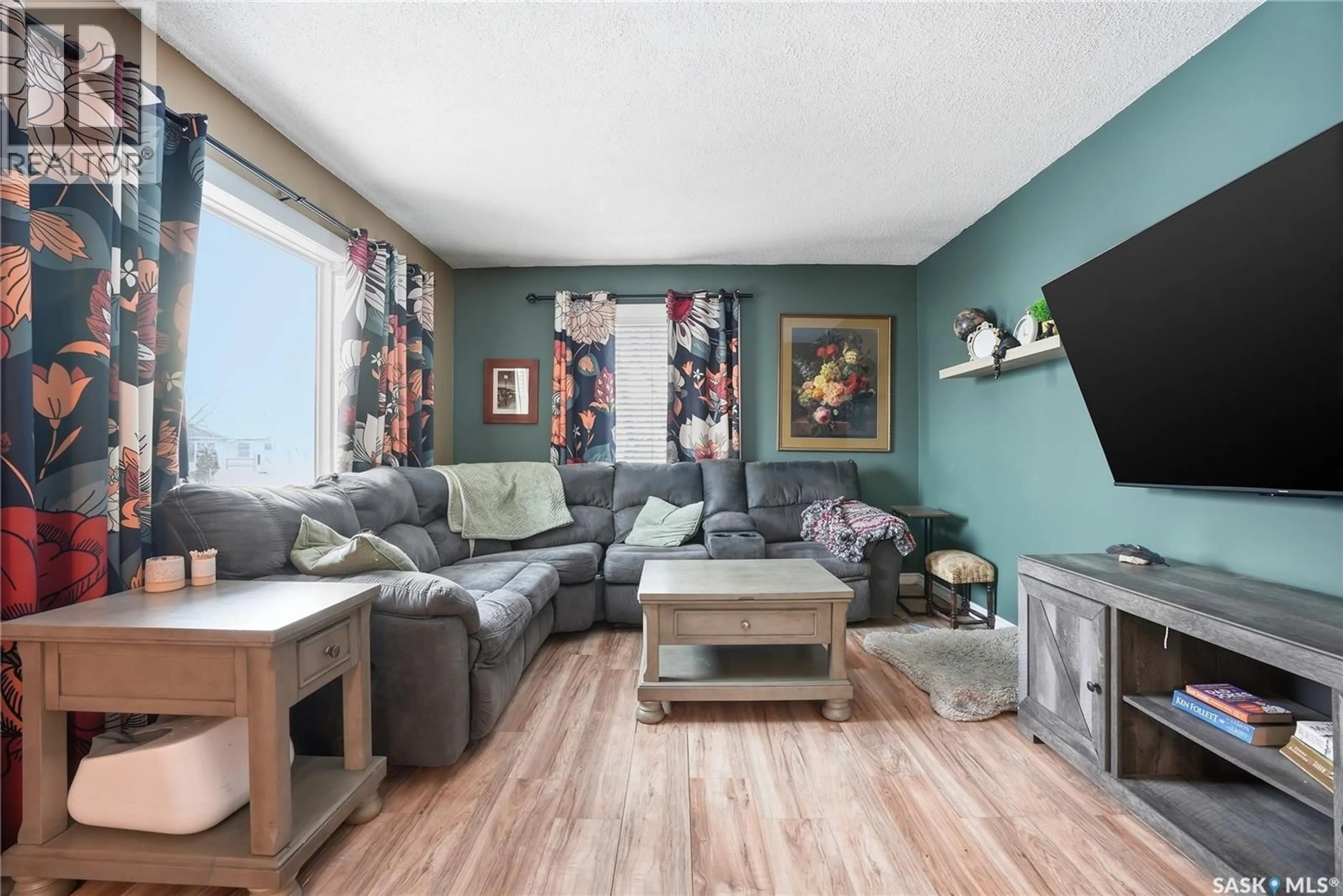 Living room with furniture, wood/laminate floor for 5 4TH AVENUE, Martensville Saskatchewan S7K1X2
