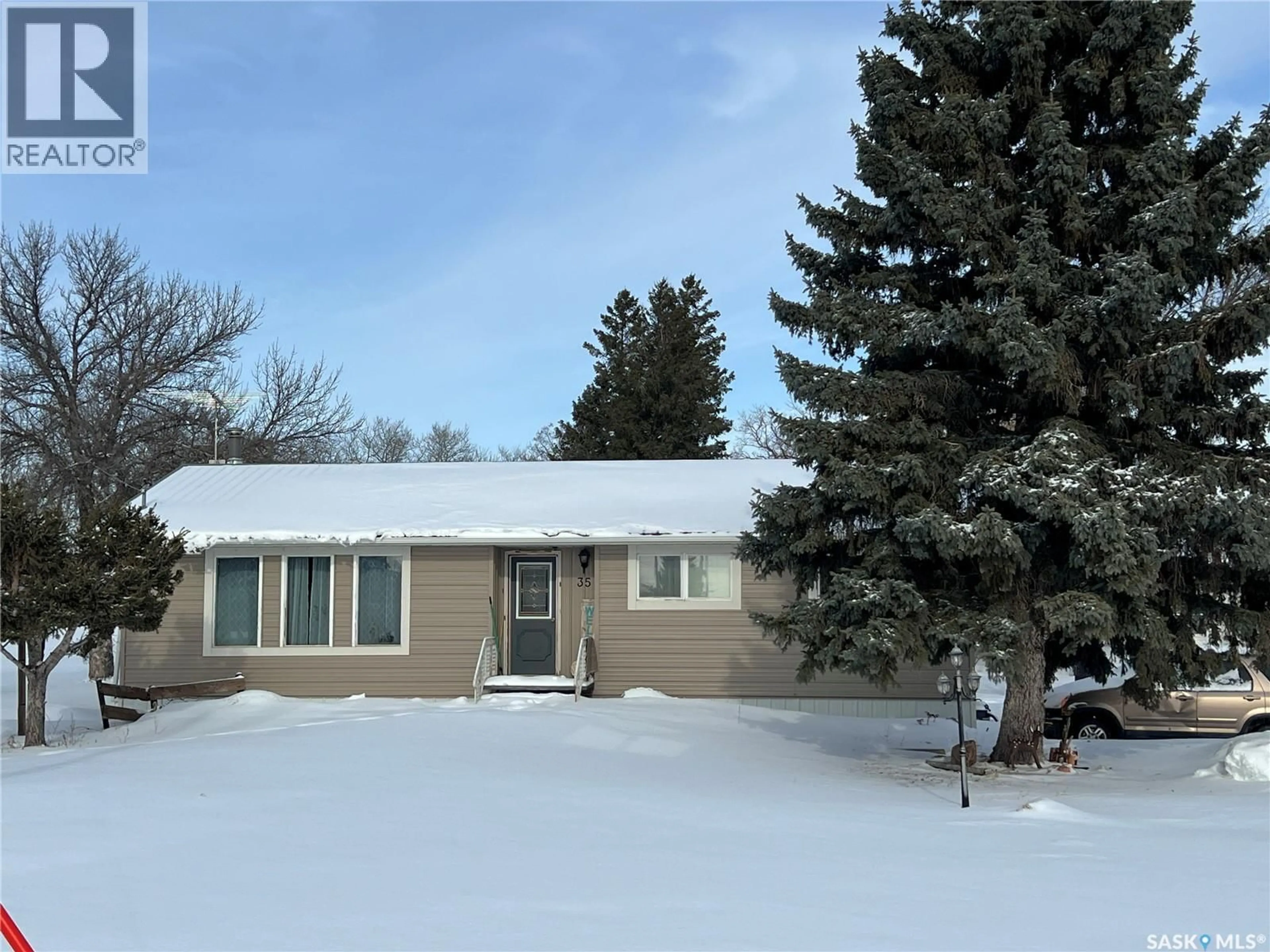Home with vinyl exterior material, street for 35 ASSINIBOIA AVENUE, Dubuc Saskatchewan S0A0R0