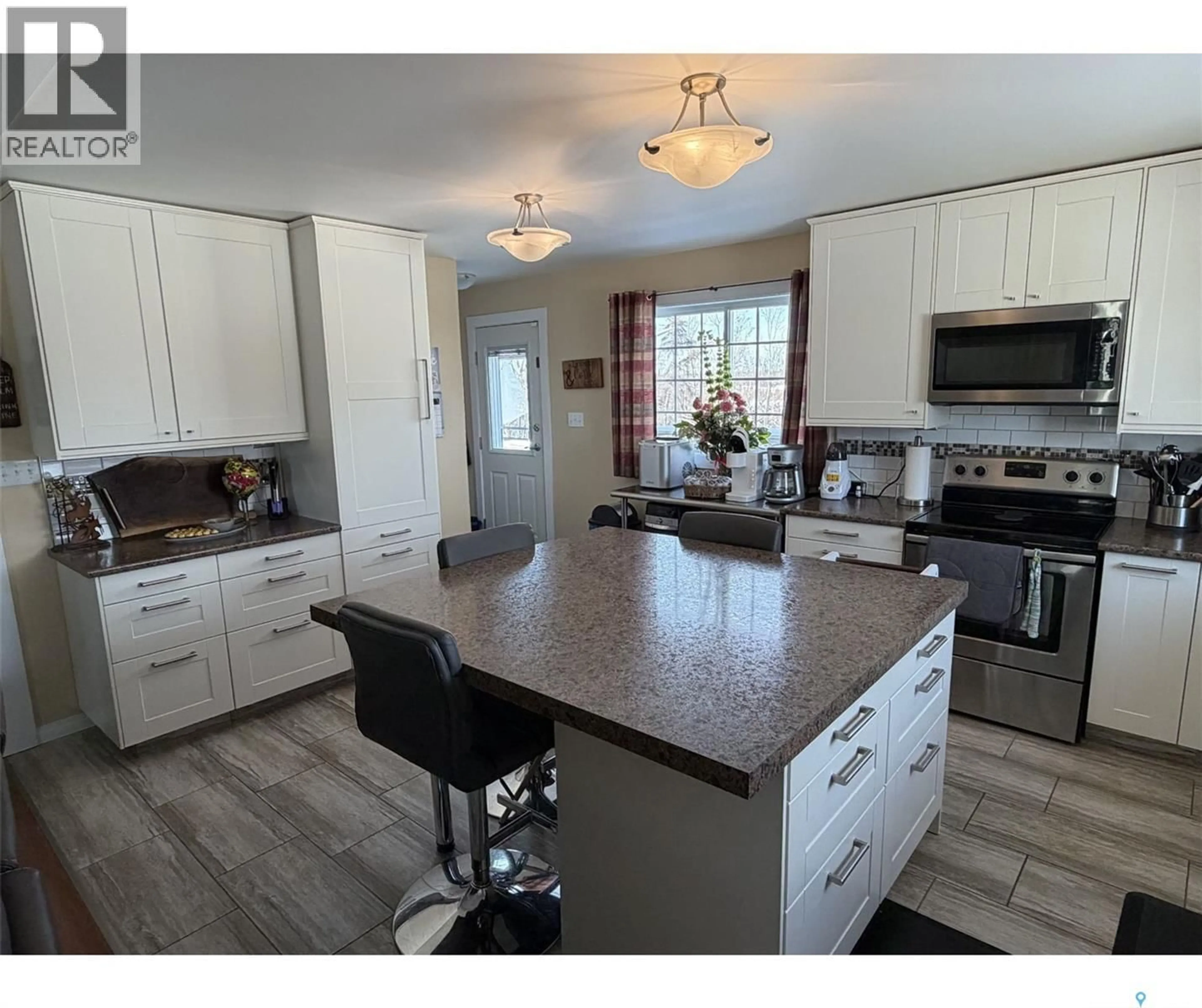 Open concept kitchen, wood/laminate floor for 127 HASTINGS STREET, La Ronge Saskatchewan S0J1L0