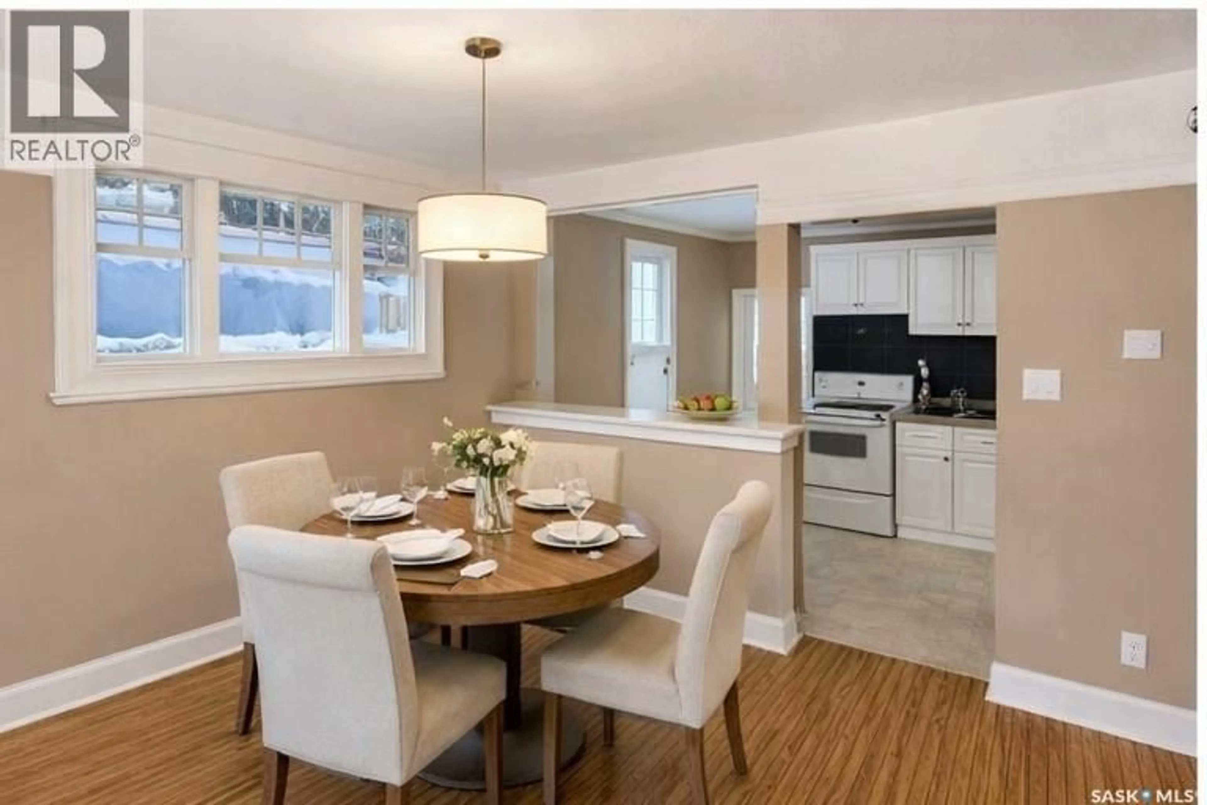 Open concept kitchen, wood/laminate floor for 824 COLLEGE AVENUE, Regina Saskatchewan S4S0X9