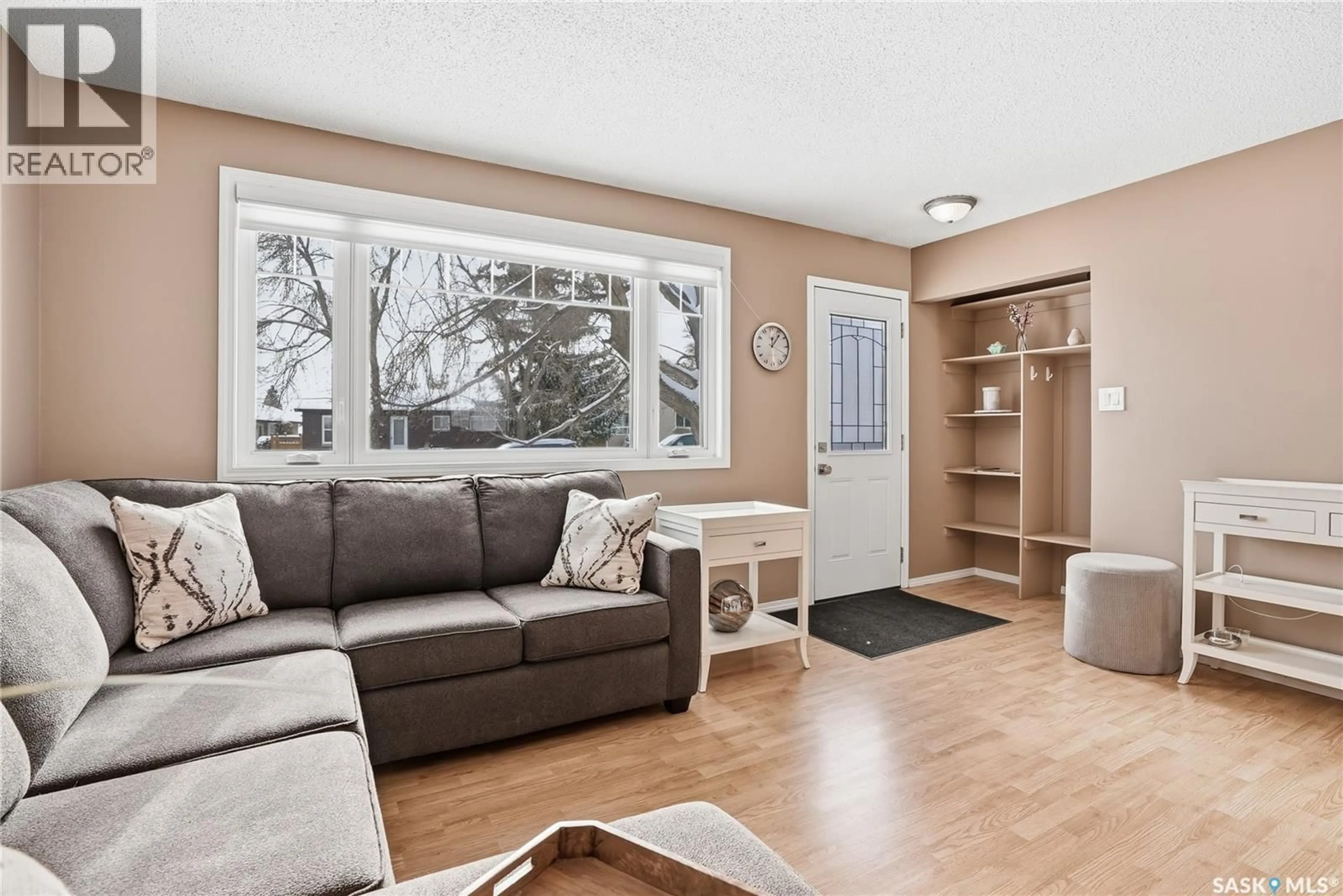Living room with furniture, wood/laminate floor for 66 CONFEDERATION CRESCENT, Saskatoon Saskatchewan S7L4V2
