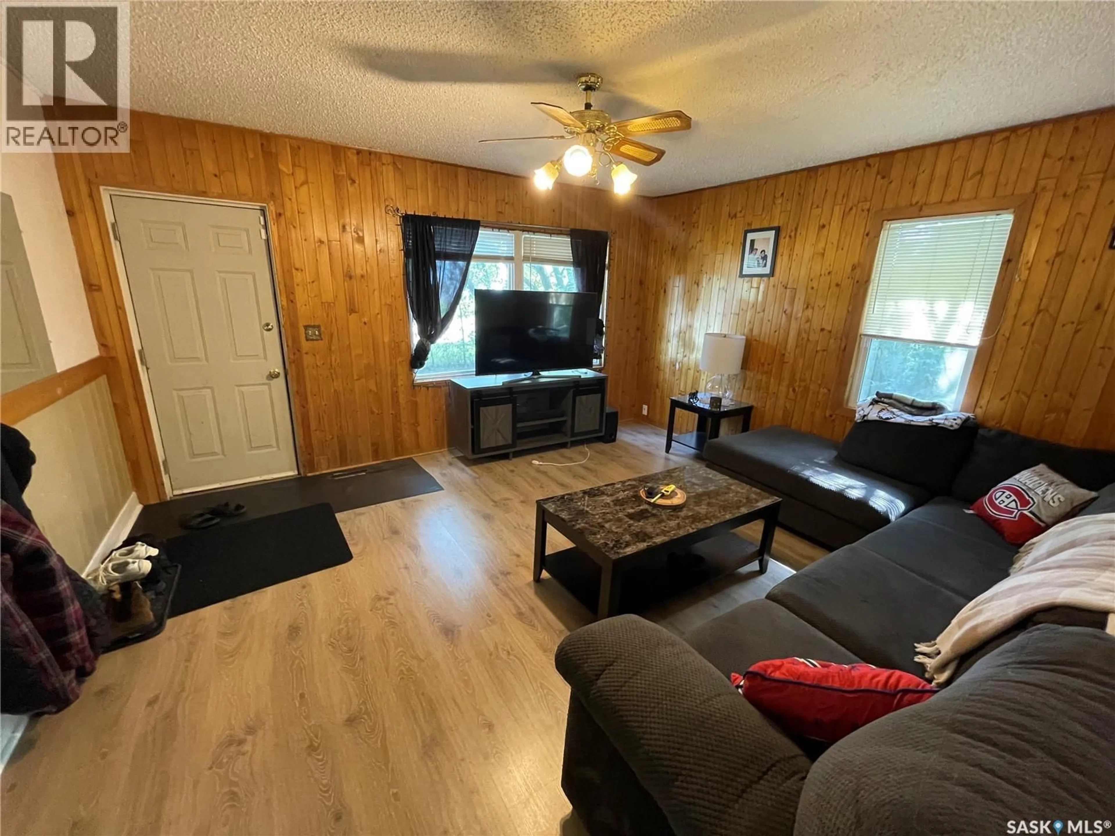 Living room with furniture, wood/laminate floor for 407 3RD STREET, Meadow Lake Saskatchewan S9X1H7