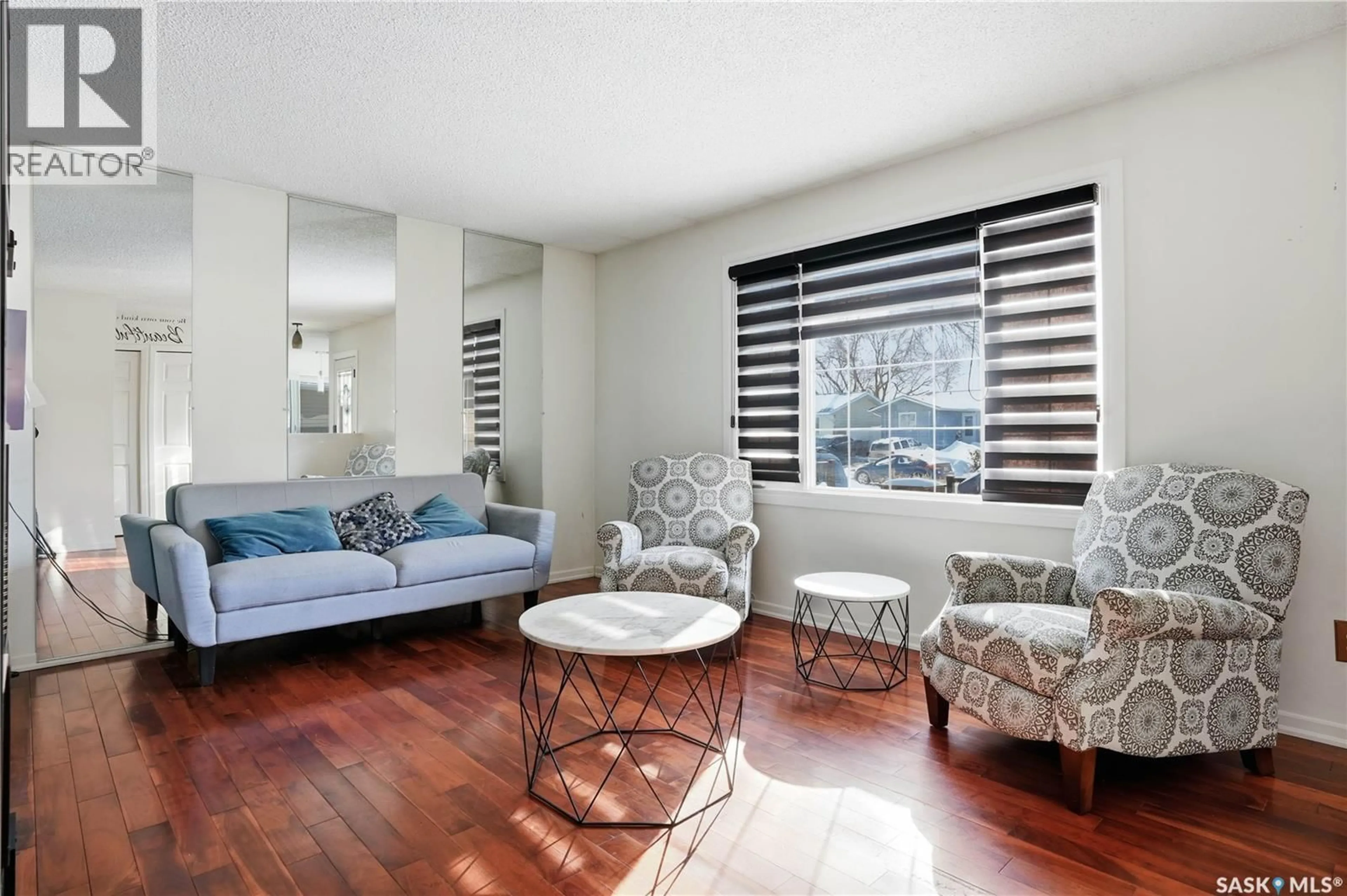 Living room with furniture, wood/laminate floor for 70 PAYNTER CRESCENT, Regina Saskatchewan S4X1H6