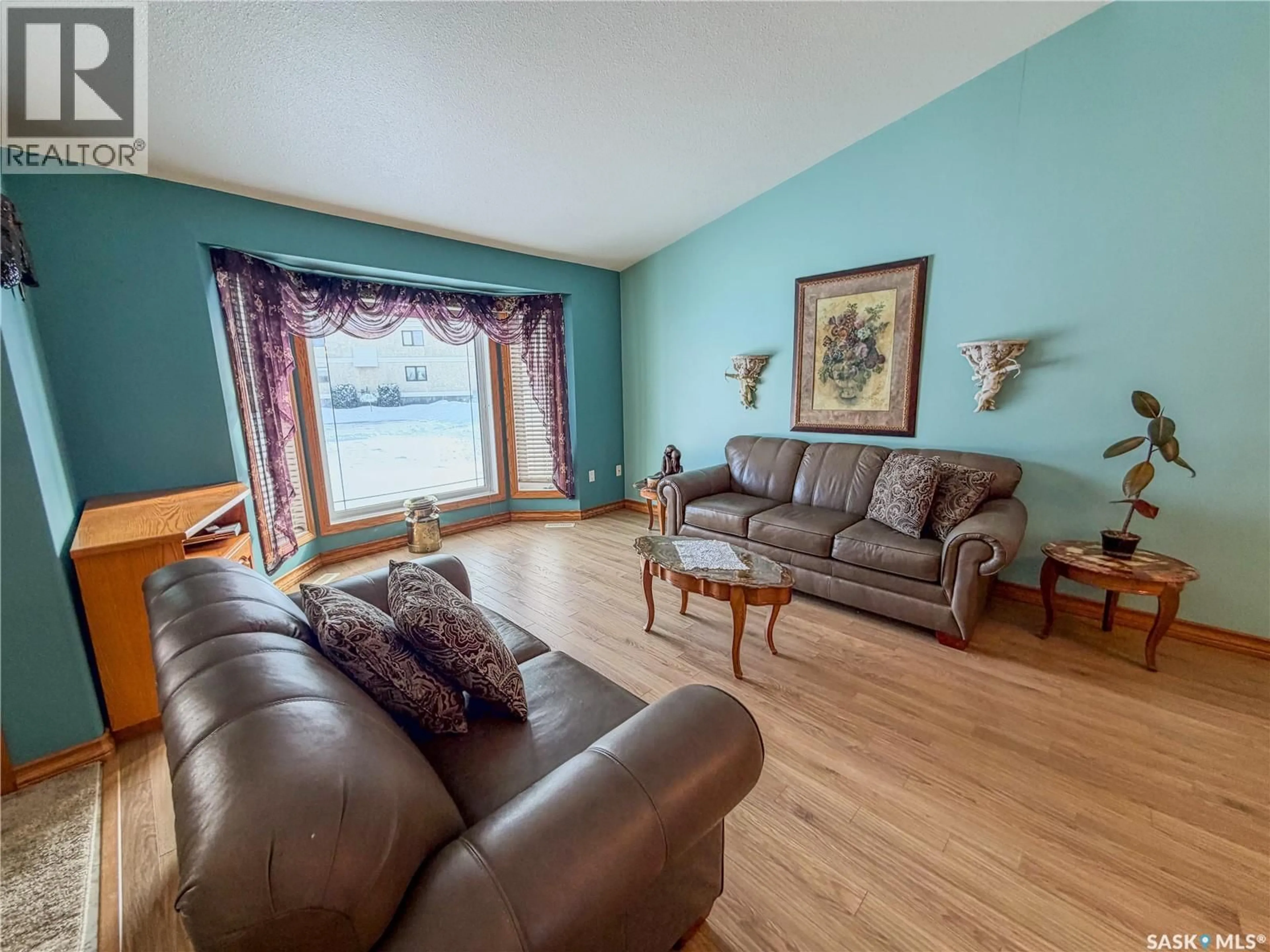 Living room with furniture, wood/laminate floor for 52 RUSSELL DRIVE, Yorkton Saskatchewan S3N3W2