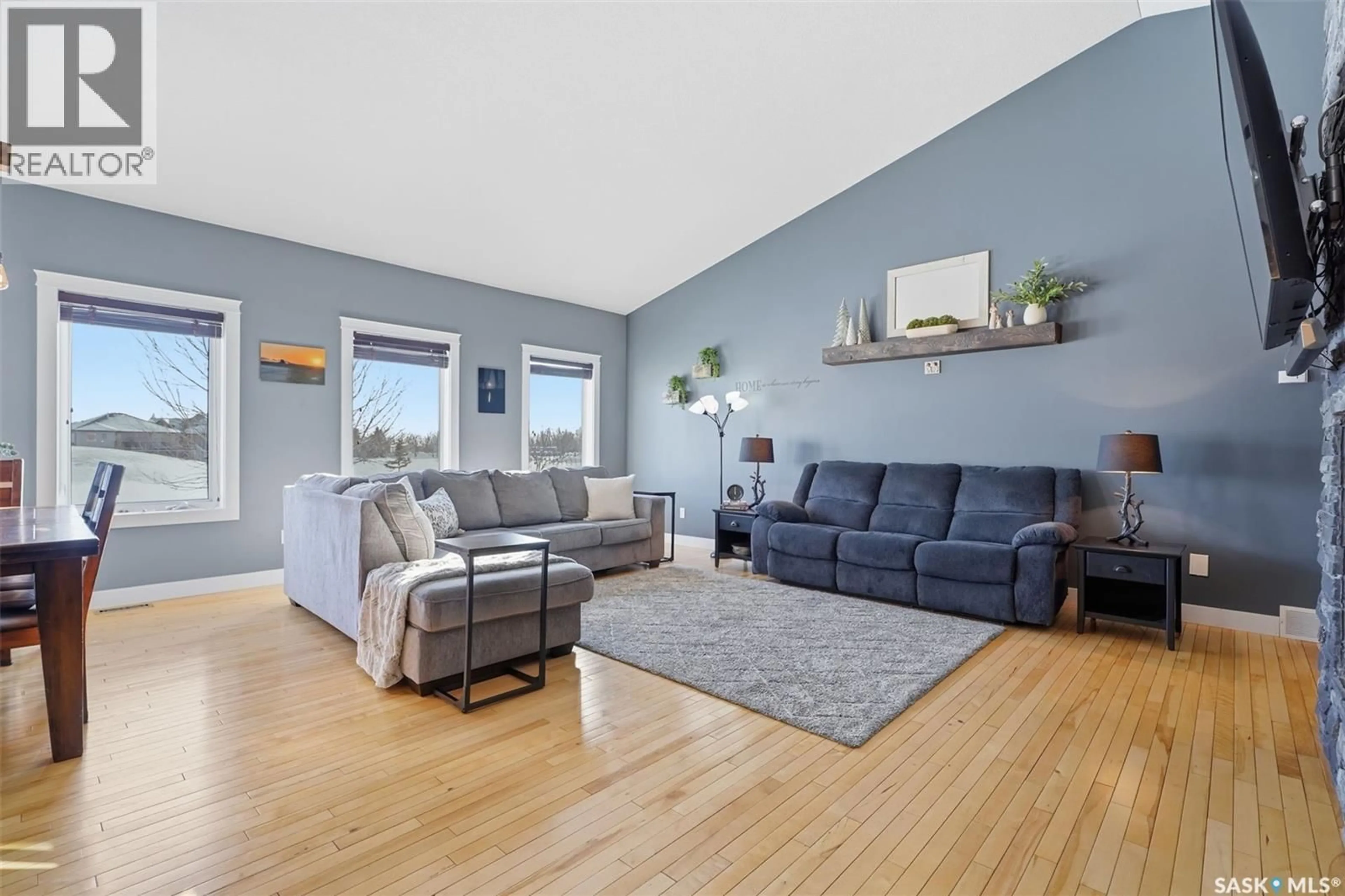 Living room with furniture, wood/laminate floor for 307 BROOKSIDE DRIVE, Warman Saskatchewan S0K0A1